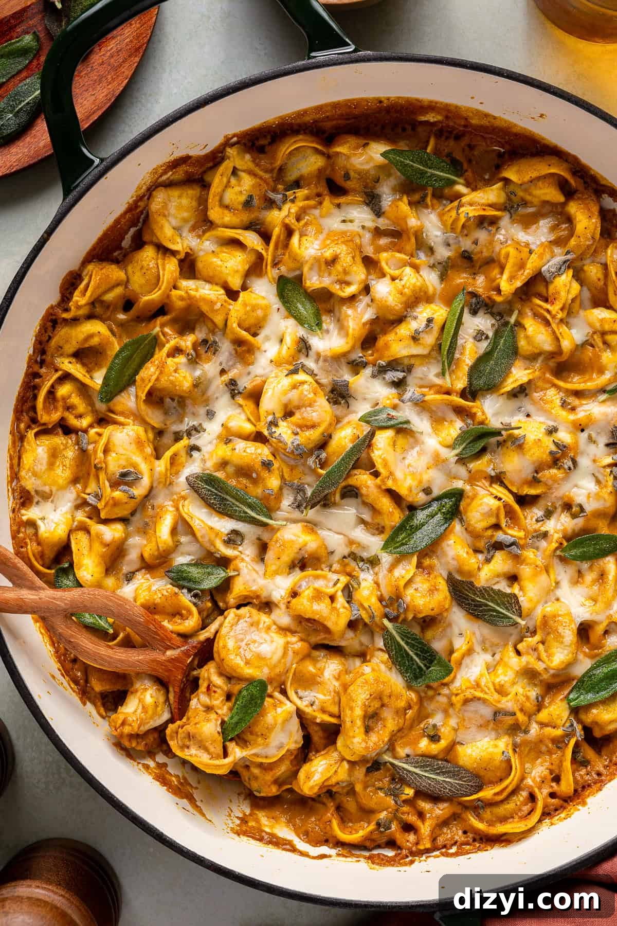 A finished pan of Creamy Pumpkin Tortellini, garnished with sage.