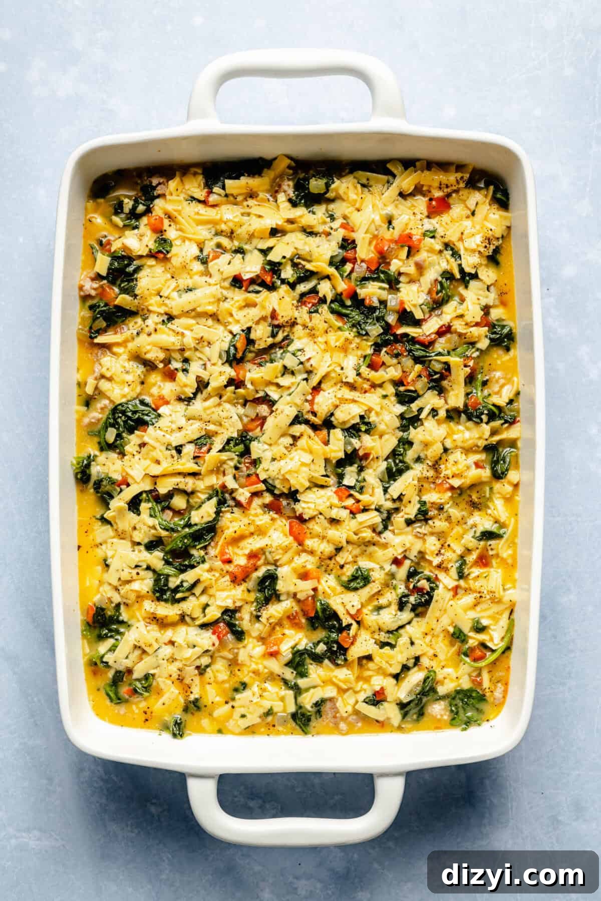 Classic Old Fashioned Breakfast Casserole Recipe 4 The Old Fashioned Breakfast Casserole assembled in a white casserole dish and ready to be baked in the oven.