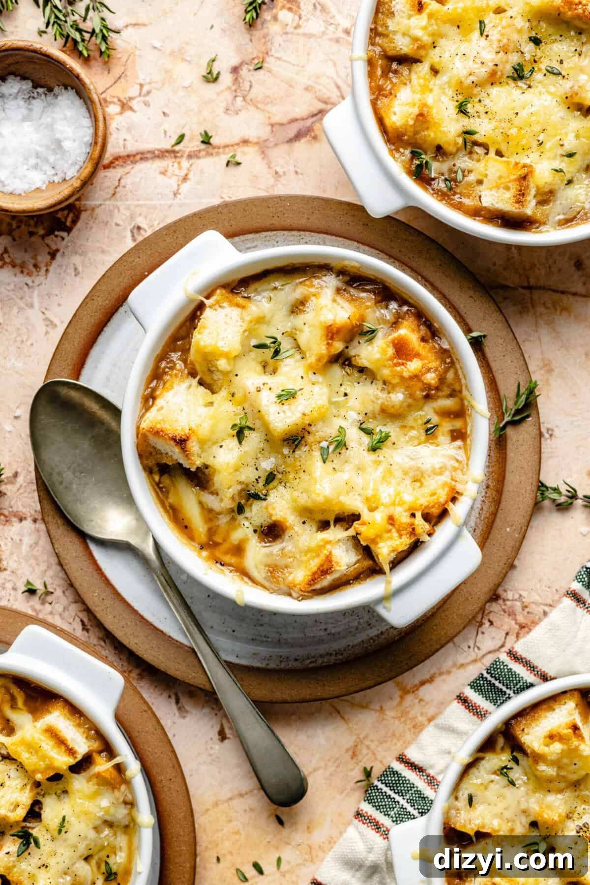 French Onion Soup in bowls with cheese melted on top.