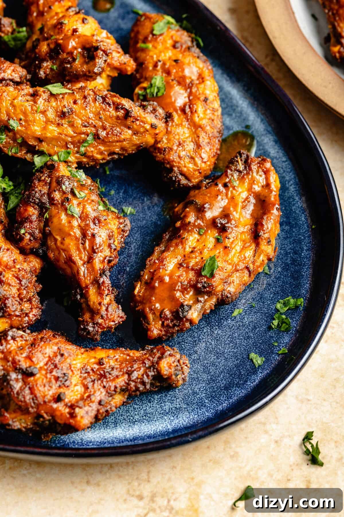 Cajun Spiced Chicken Wings on dark blue platter.