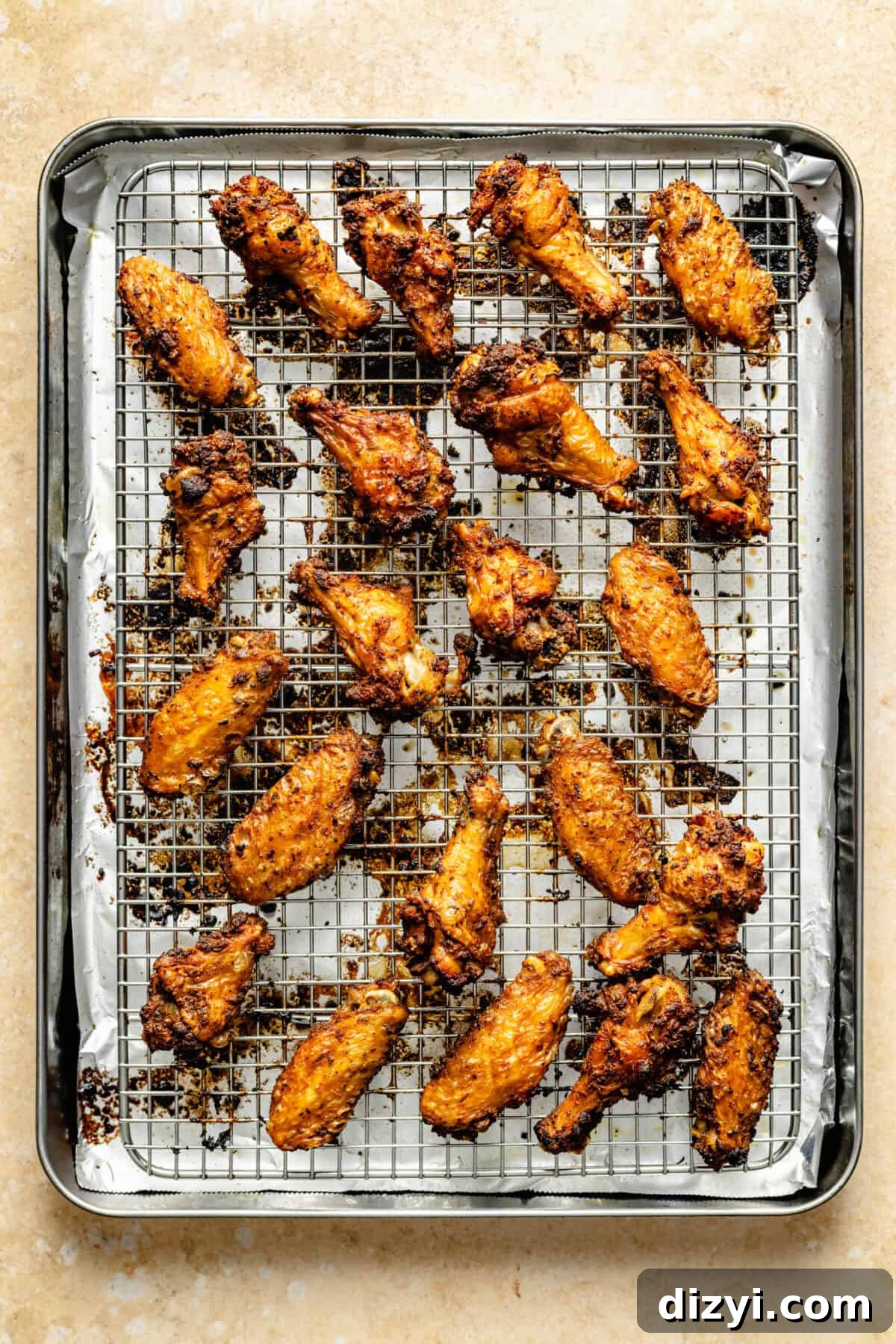 Cajun Spiced Chicken Wings on a cooling rack on top of a sheet pan.