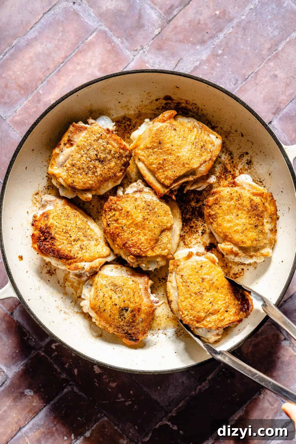 Seared chicken thighs in braiser.