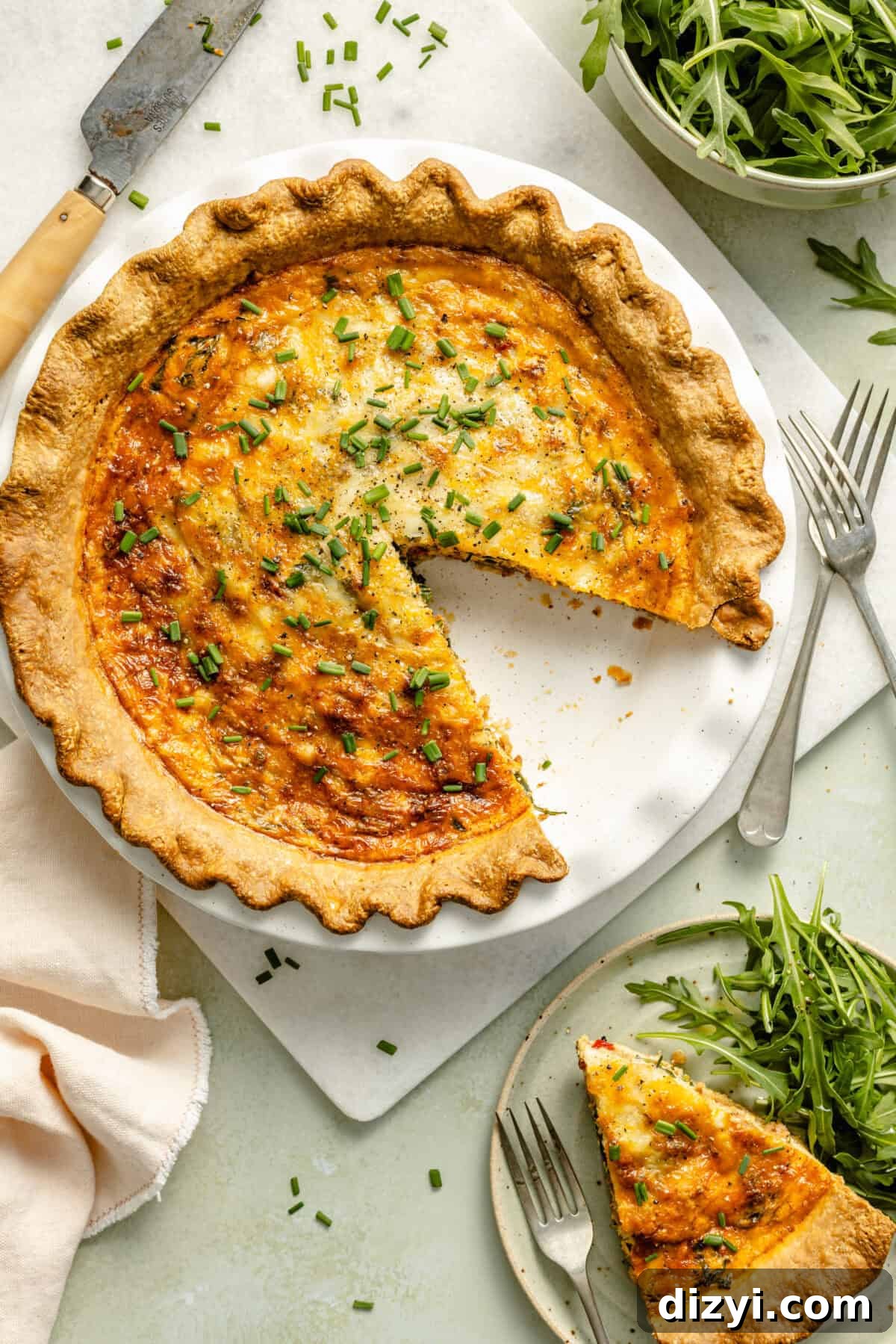 Italian Sausage and Arugula Quiche with slice on plate.