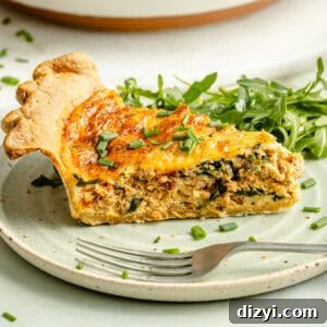 Slice of Italian Sausage and Arugula Quiche on plate.