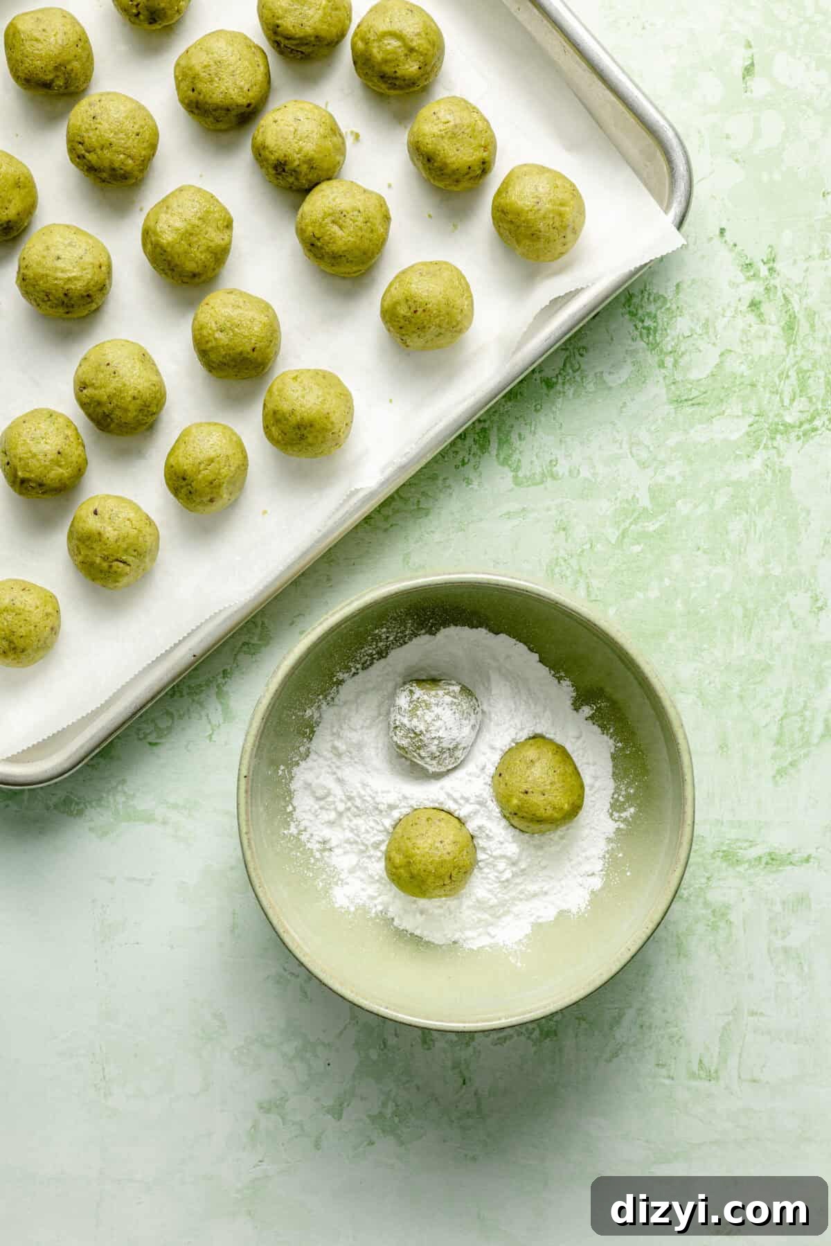 Pistachio Italian Wedding Cookies: Grain-Free Recipe 5 Dough rolled and getting rolled into powdered sugar.
