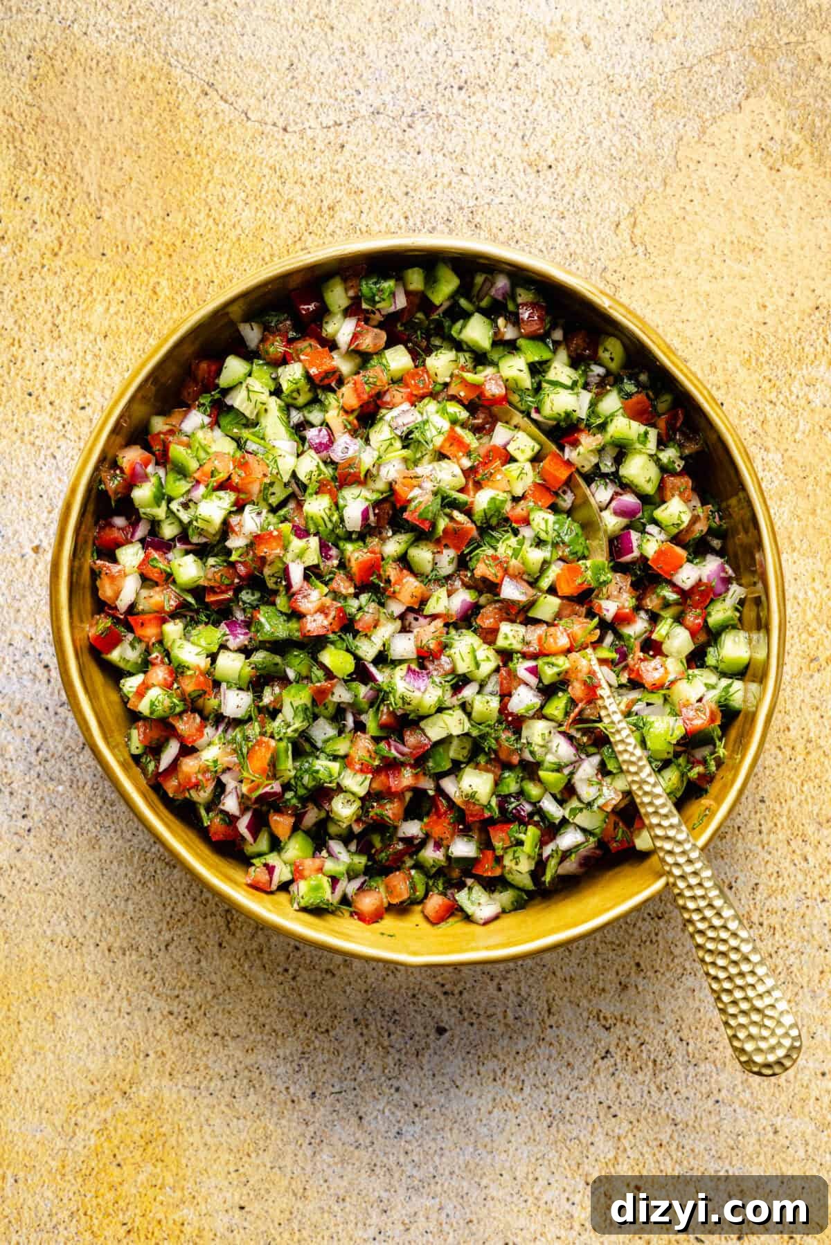 Shirazi salad in yellow bowl.