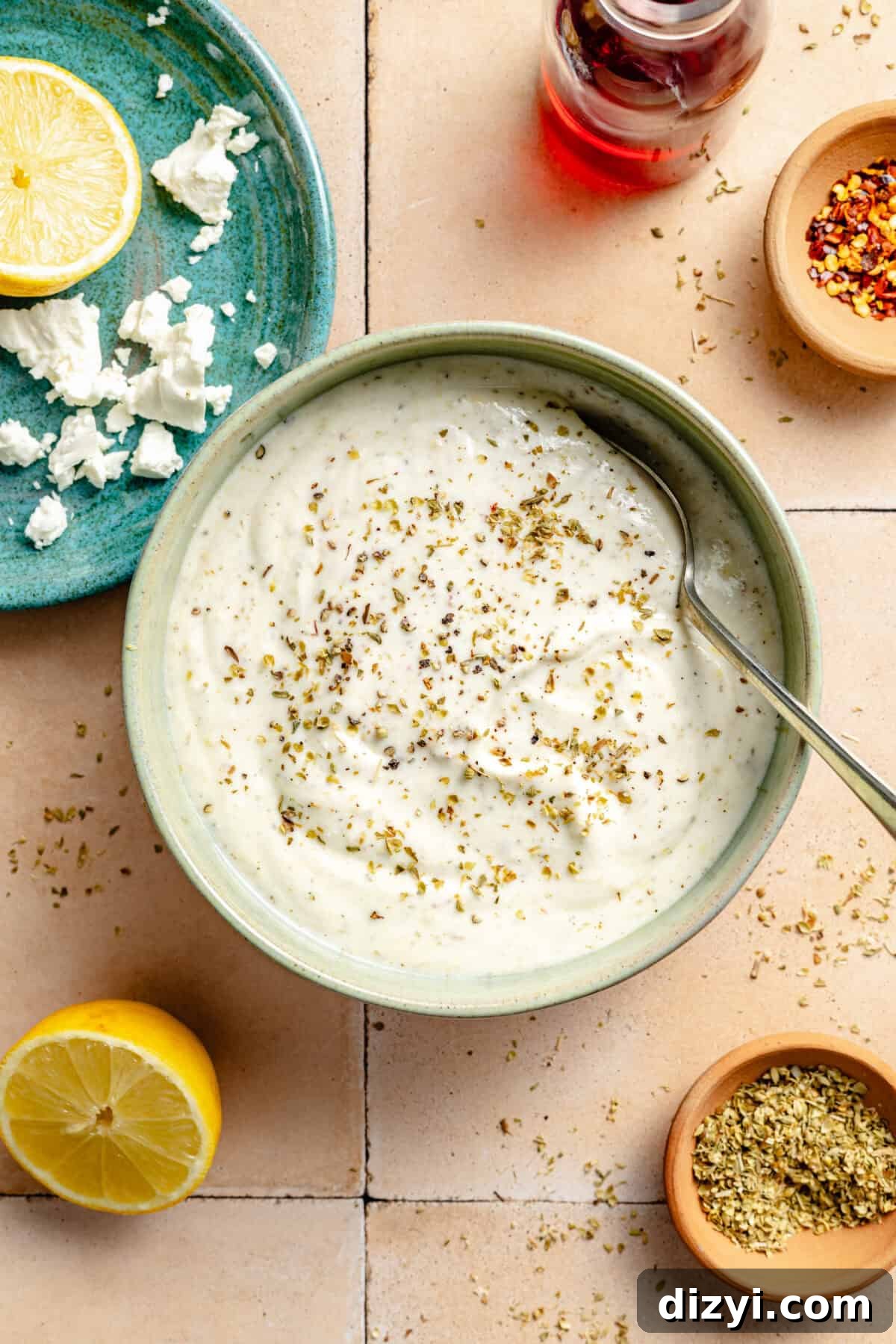 Classic Greek Pasta Salad with Feta and Kalamata Olives 3 a light green bowl with creamy feta sauce with lemon and crumbled feta cheese