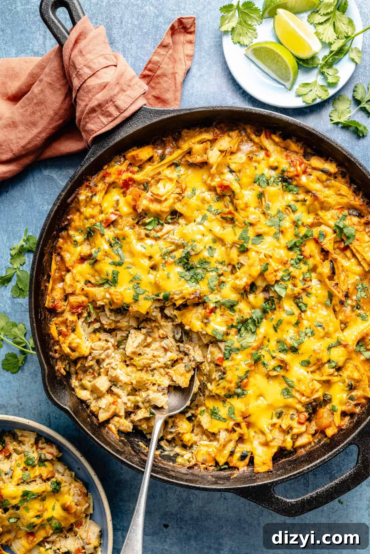 an up-close photo of cheesy chicken casserole with a spoon scooping out some of the mixture