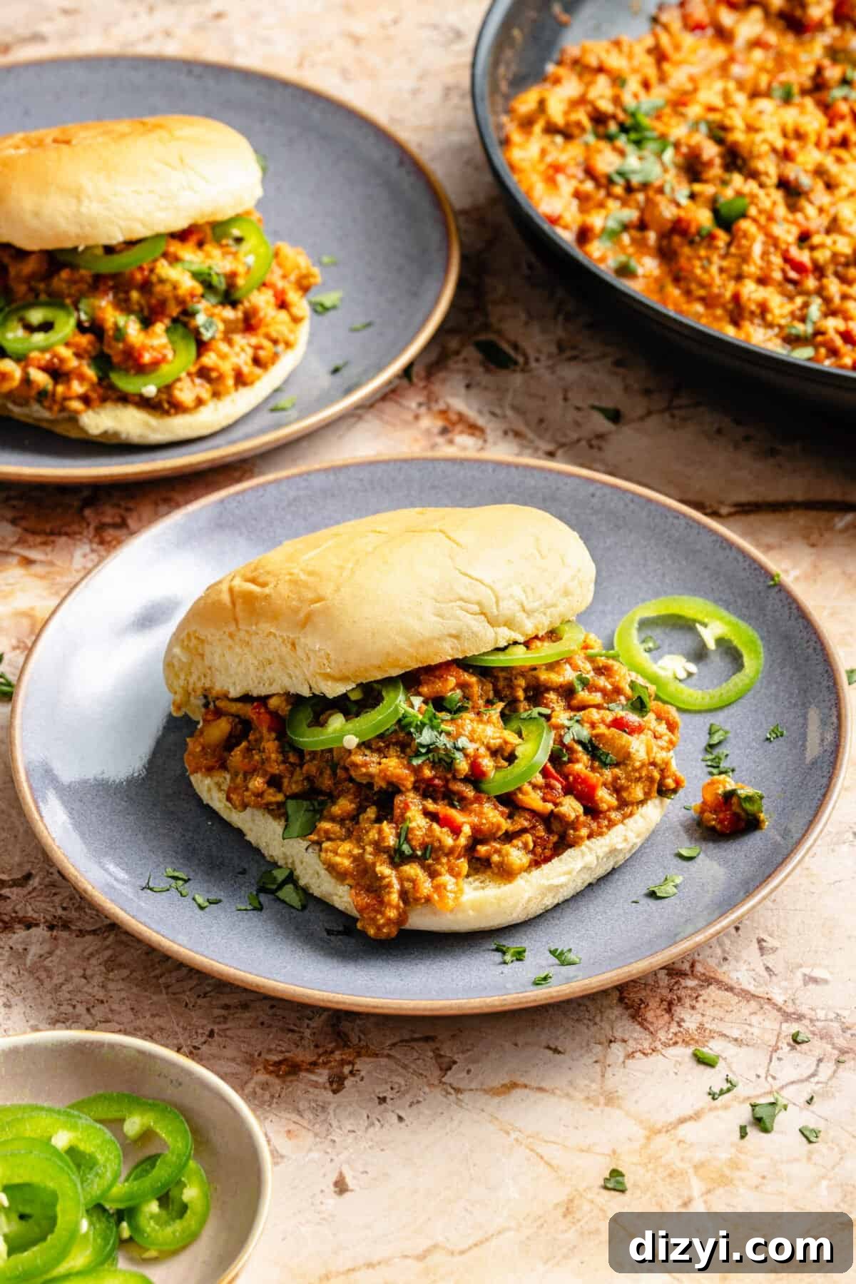 curried turkey sloppy joes on soft potato buns with thinly sliced serrano peppers