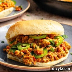 a close-up of curried turkey sloppy joes with thinly sliced serrano peppers on potato buns