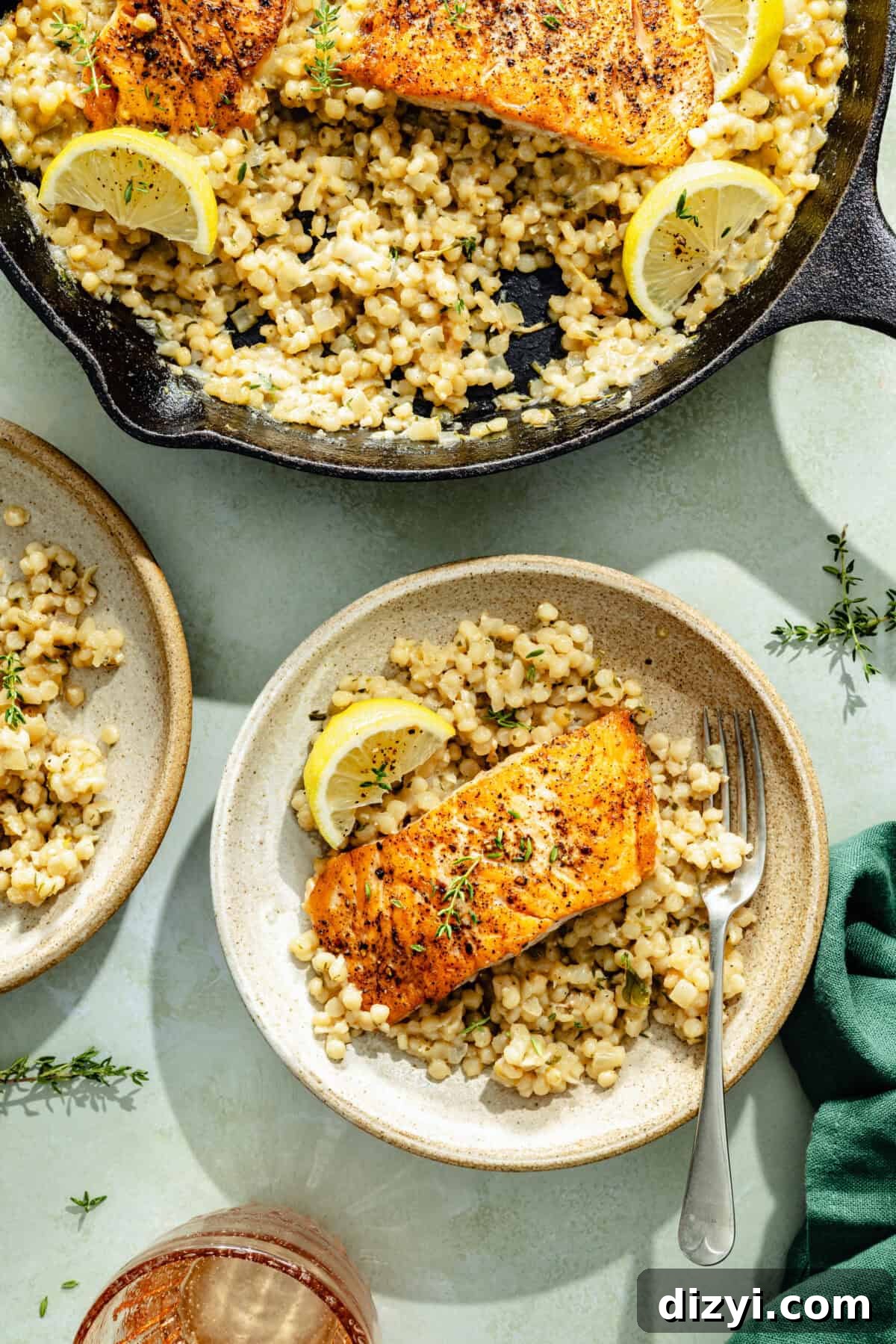 a portion of seared salmon and herby couscous with lemons