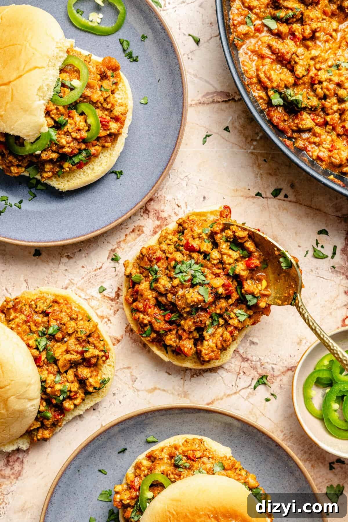 curried turkey sloppy joes on potato buns with thinly sliced serrano peppers