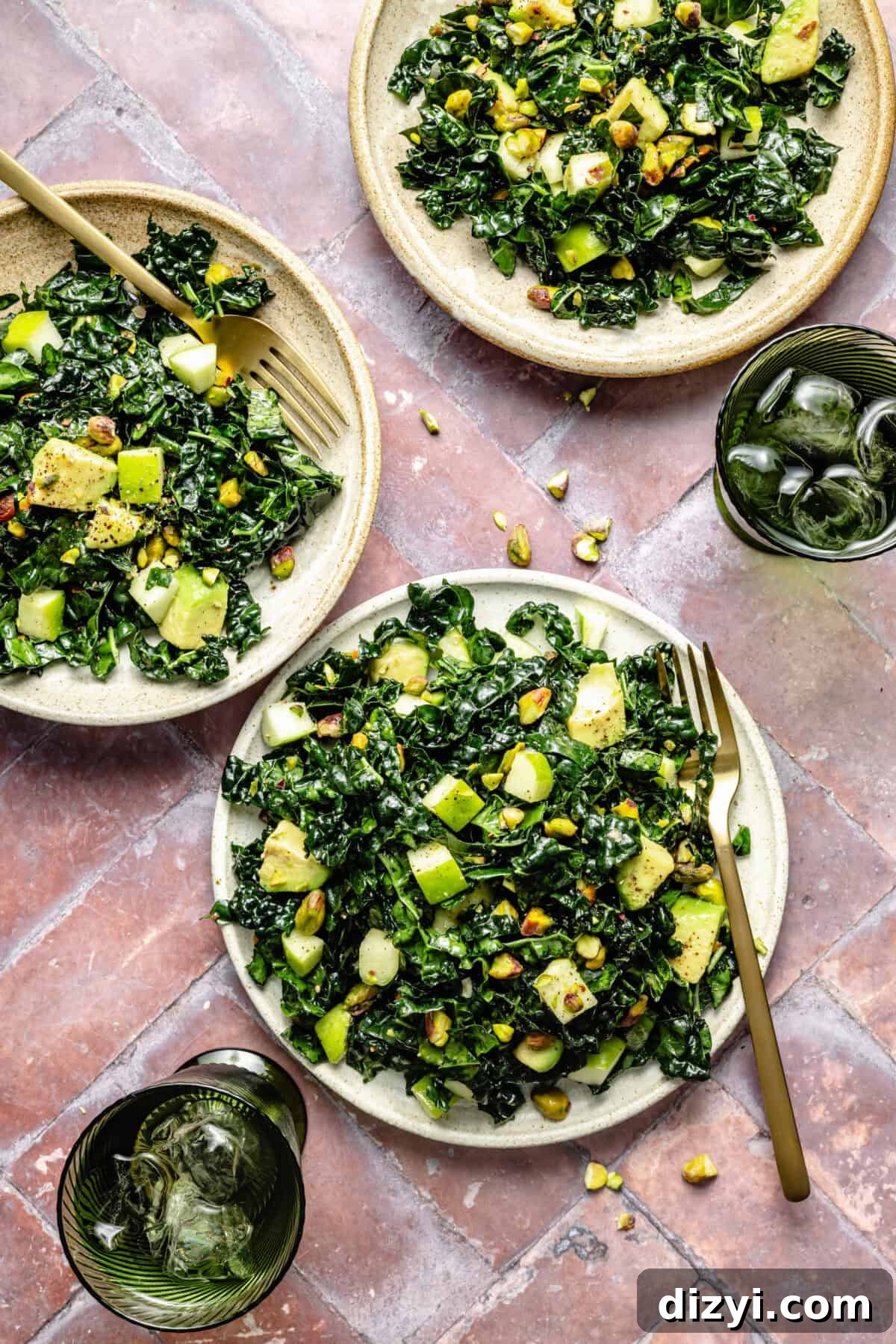Citrus Kale Detox Salad with Lemon Ginger Dressing 2 three plates of tossed kale salad with apples, avocado, and pistachios