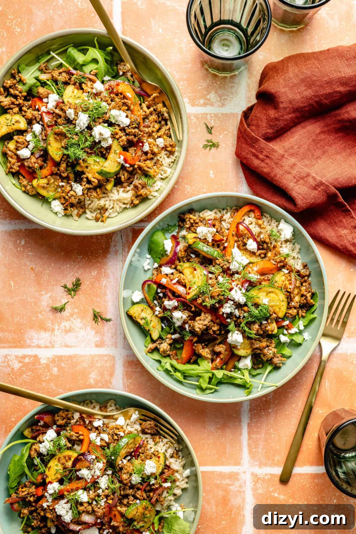 One-Pan Mediterranean Beef and Vegetable Skillet Recipe 2 three plates of prepared Mediterranean-inspired ground beef stir fry with sautéed vegetables, feta cheese, and fresh herbs
