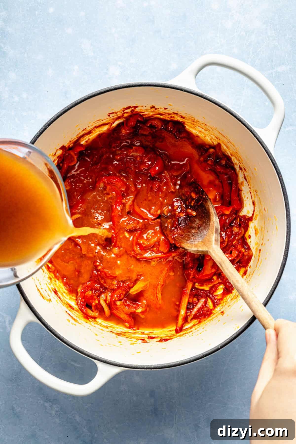 Spicy Gochujang Coconut Shrimp Noodle Soup 3 a large soup pot with hot broth and bell peppers