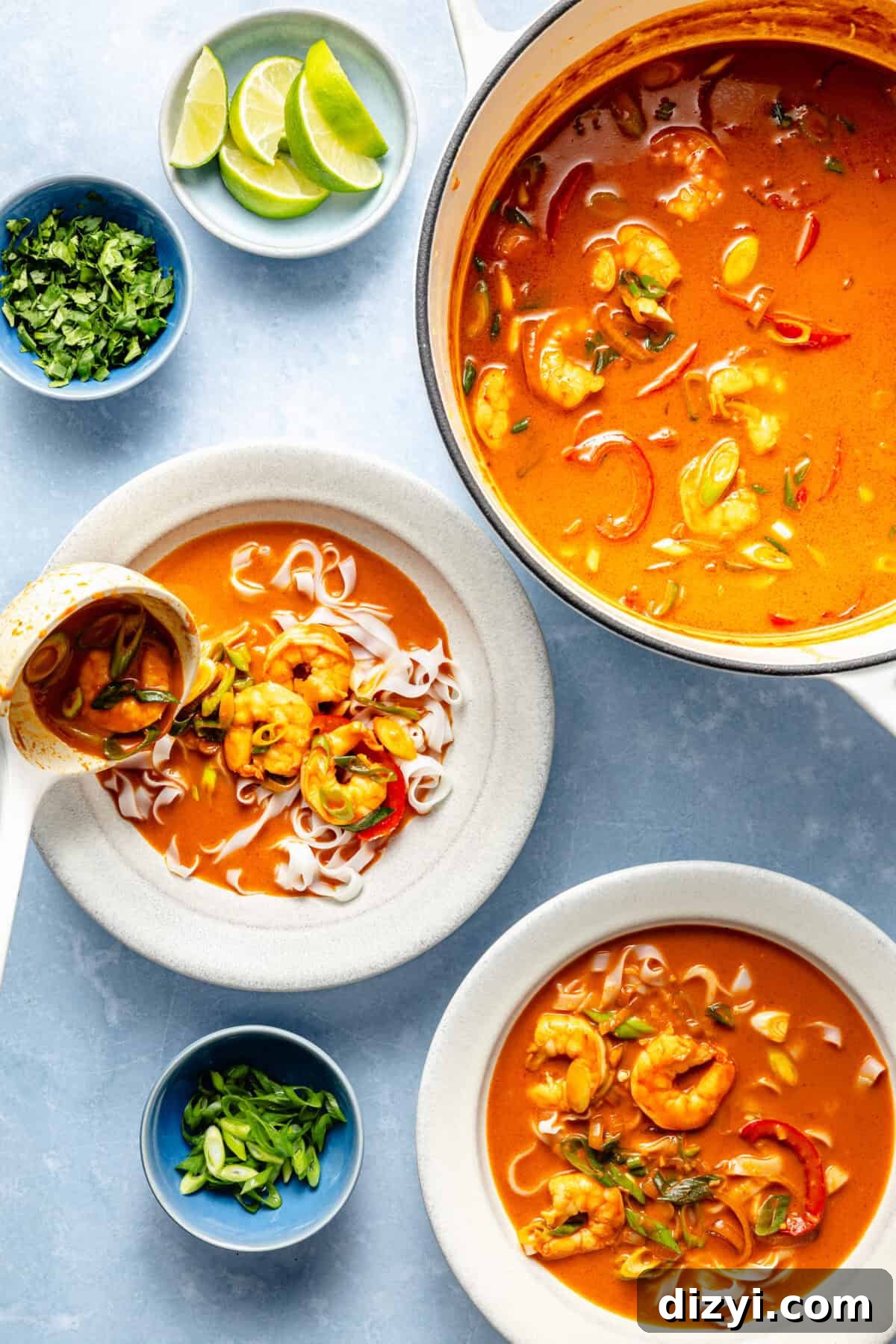 Spicy Gochujang Coconut Shrimp Noodle Soup 5 two bowls of gochujang and coconut shrimp noodle soup with a side of lime and herbs