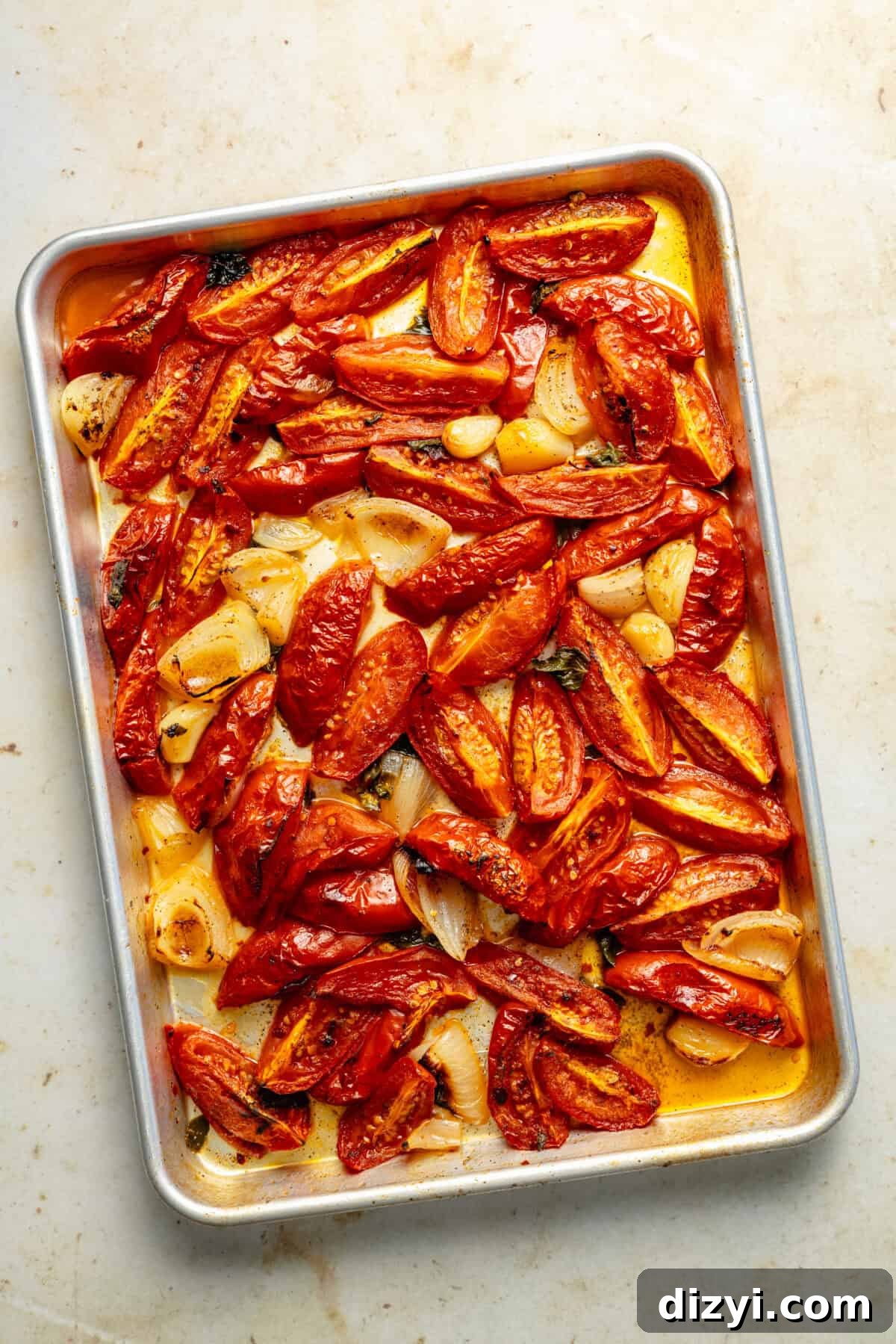 a sheet tray of roasted tomatoes and onions