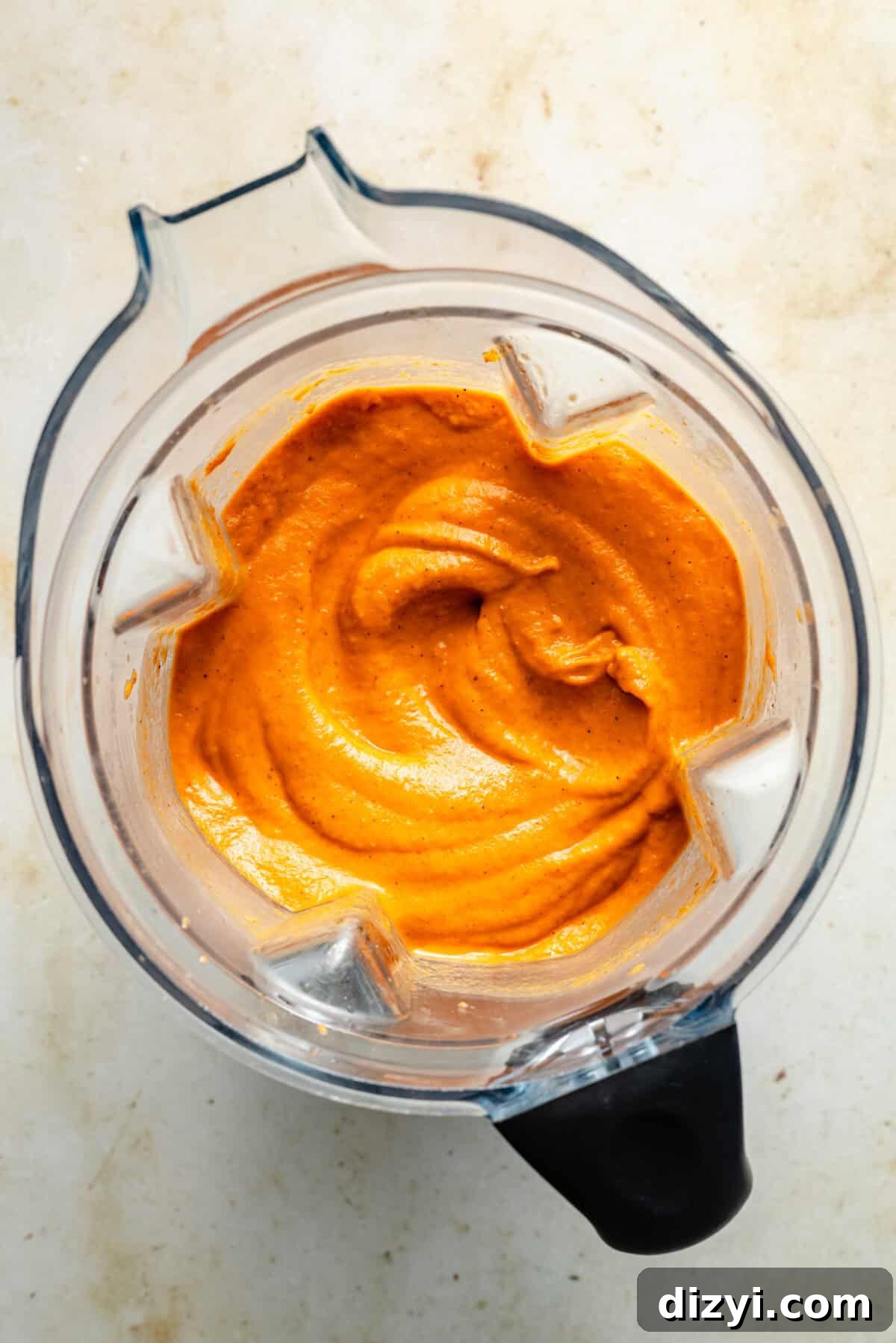 a blender filled with creamy tomato and onion soup