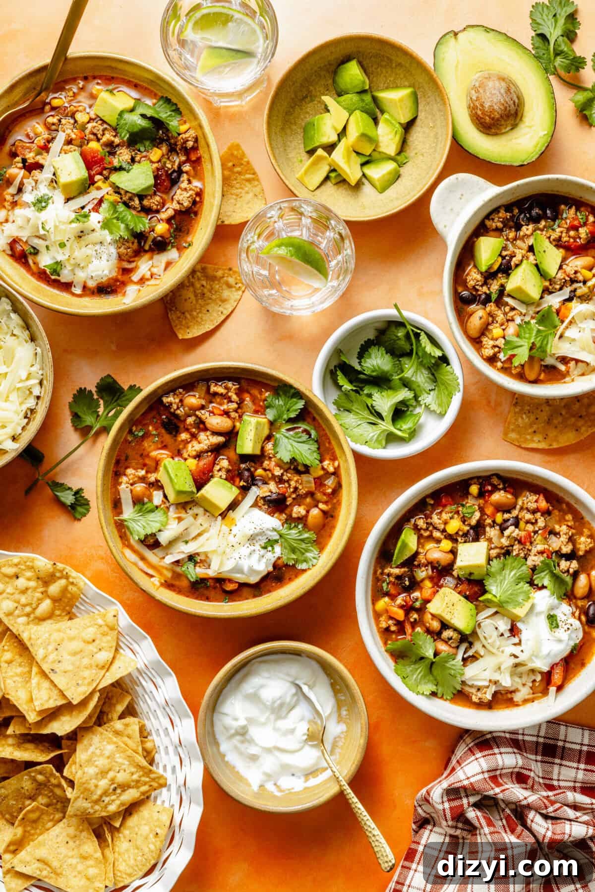 Turkey Taco Soup with Black Beans and Corn 2 three bowls of turkey taco soup garnished with fresh cilantro, cubed avocado, sour cream, and shredded cheese