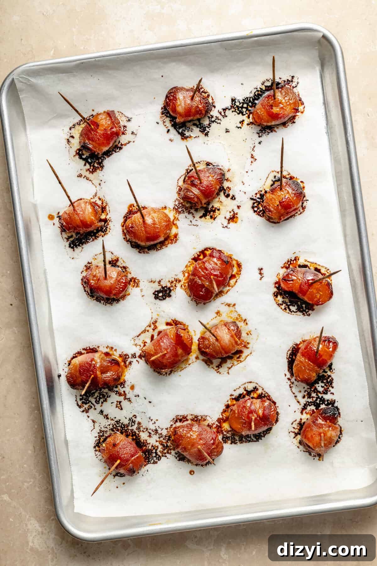 Bacon Wrapped Apricot Bites with Blue Cheese Drizzle 4 a sheet tray of baked bacon-wrapped apricots stuffed with jalapeño peppers