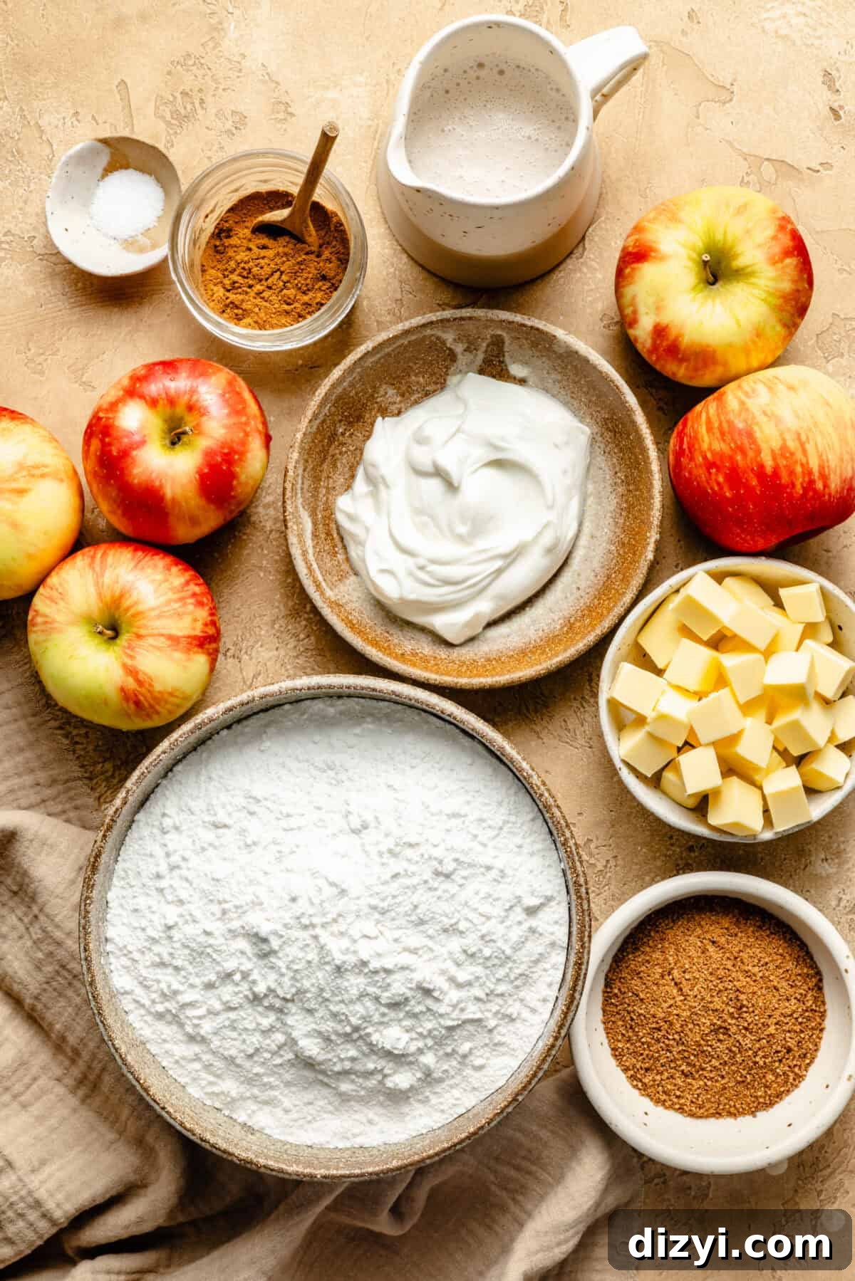 a flat lay of ingredients for an apple dump cake including butter, apples, flour, and sugar