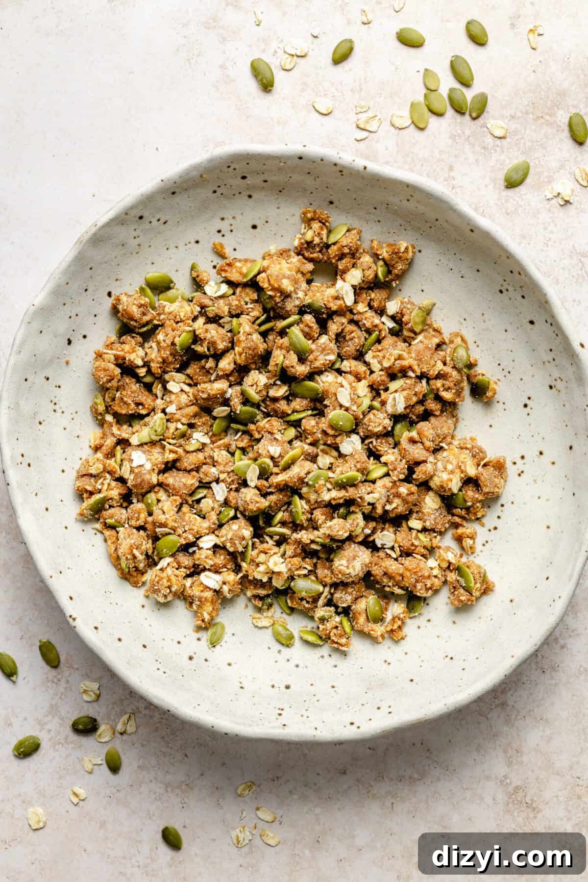 a white bowl with pumpkin seed streusel on a light background