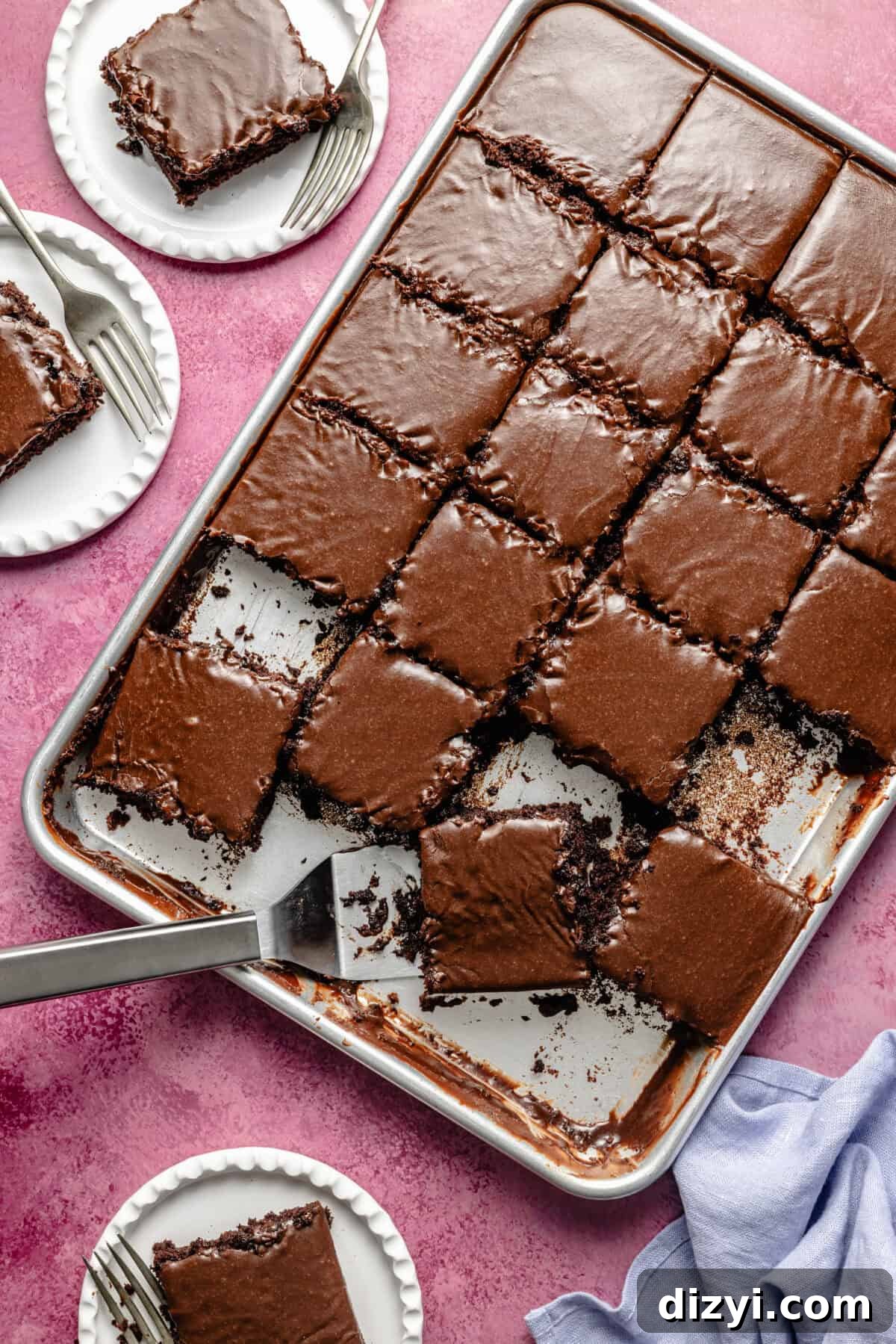 Kiki's Texas Chocolate Sheet Cake Recipe 2 a large stainless steel sheet tray with slices of chocolate frosted sheet cake