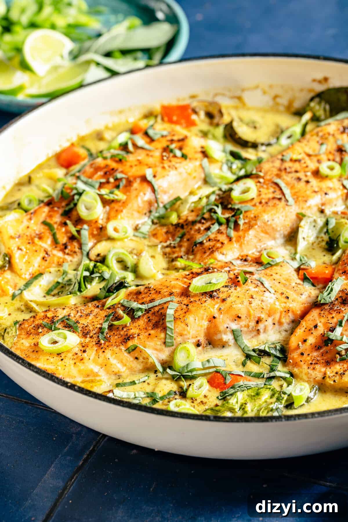 Thai Coconut Green Curry Salmon Recipe 4 Close up of Thai-Inspired Coconut Green Curry Salmon in white skillet.