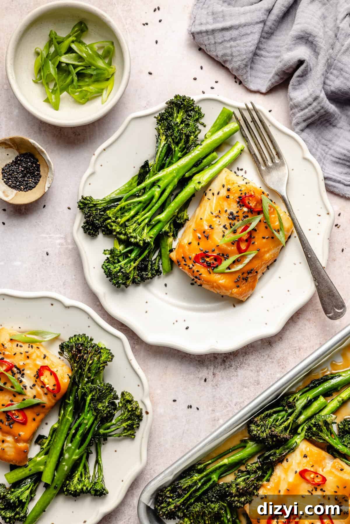 two white ruffled plates with miso-marinated cod with chile peppers and scallions plus broccolini