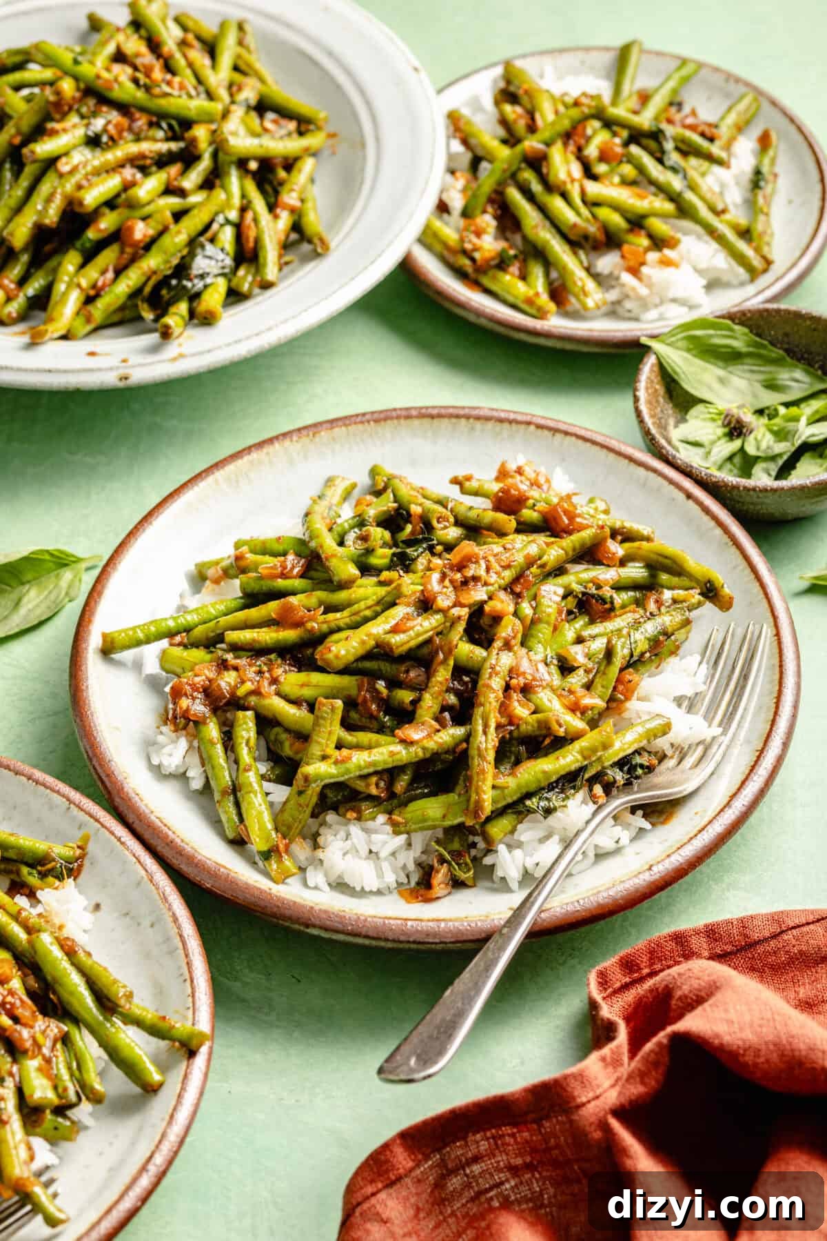 Prik King Stir-Fry: Thai Dry Red Curry 5 three white plates green beans on a bed of white rice and a green background