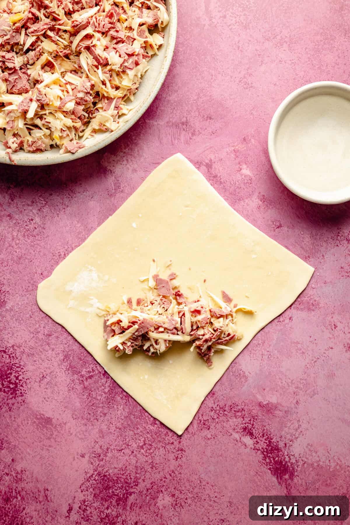 Crispy Reuben Egg Rolls with Thousand Island Dip 4 an uncooked egg roll wrapper with a reuben-inspired filling