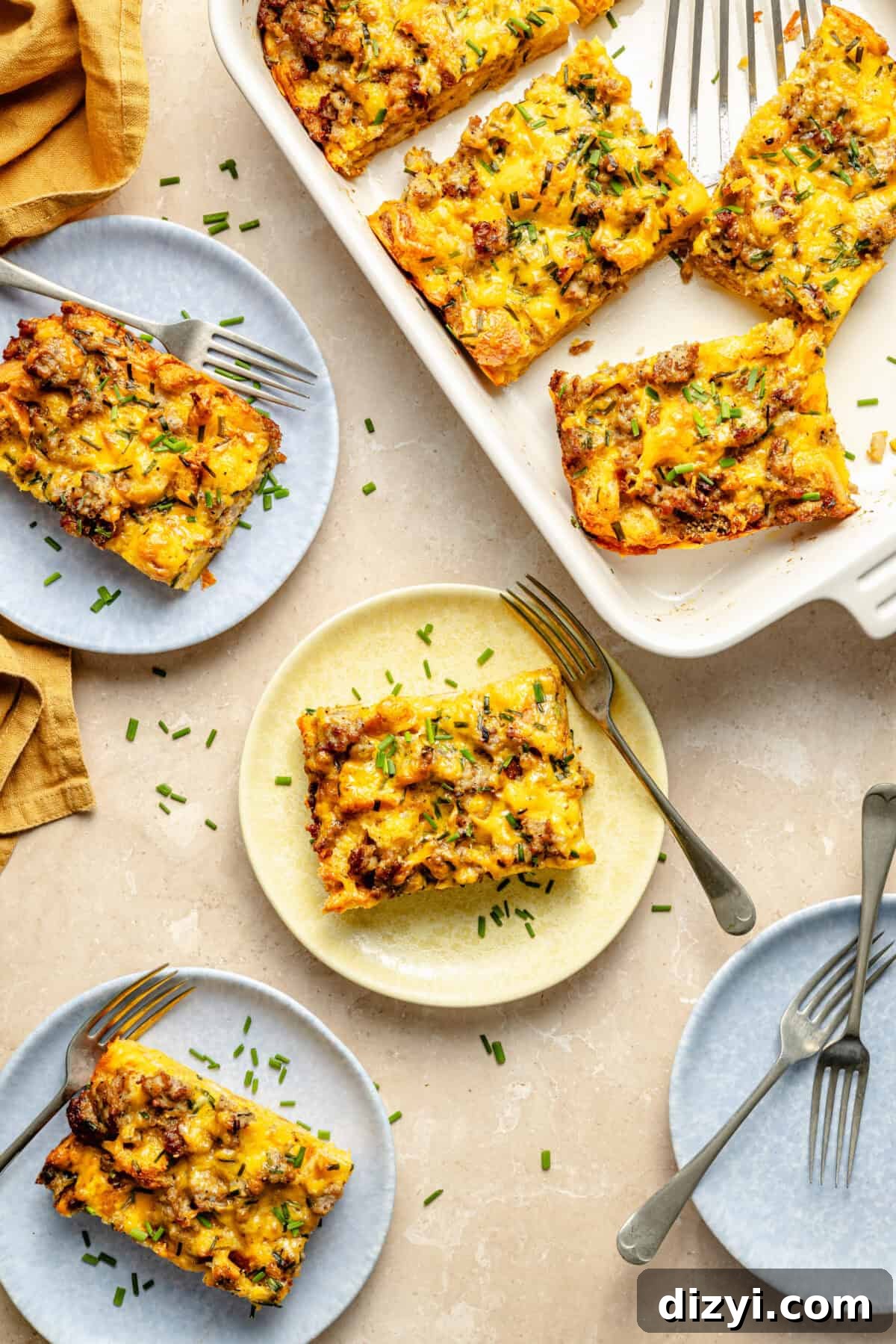 a casserole dish and blue and yellow plates with slices of sausage egg casserole