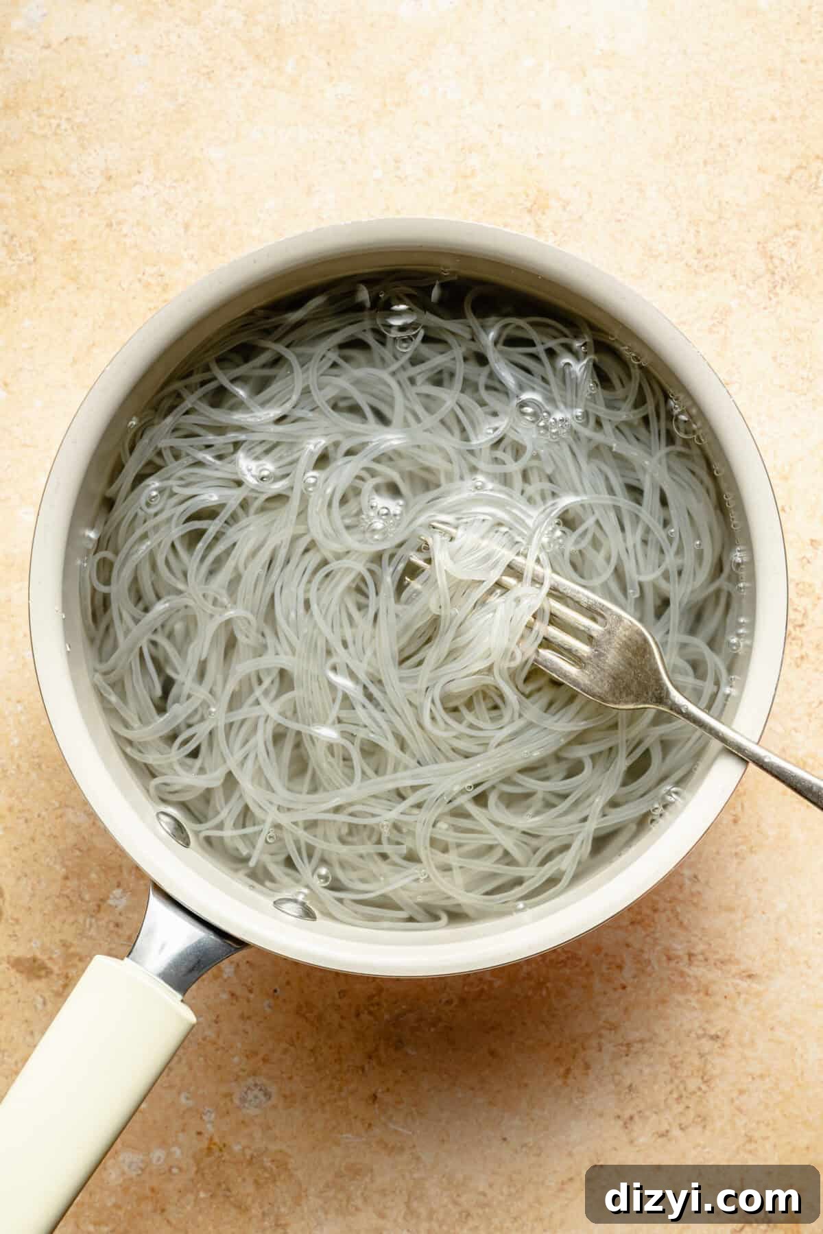 a white saucepan with glass noodles soaking in water