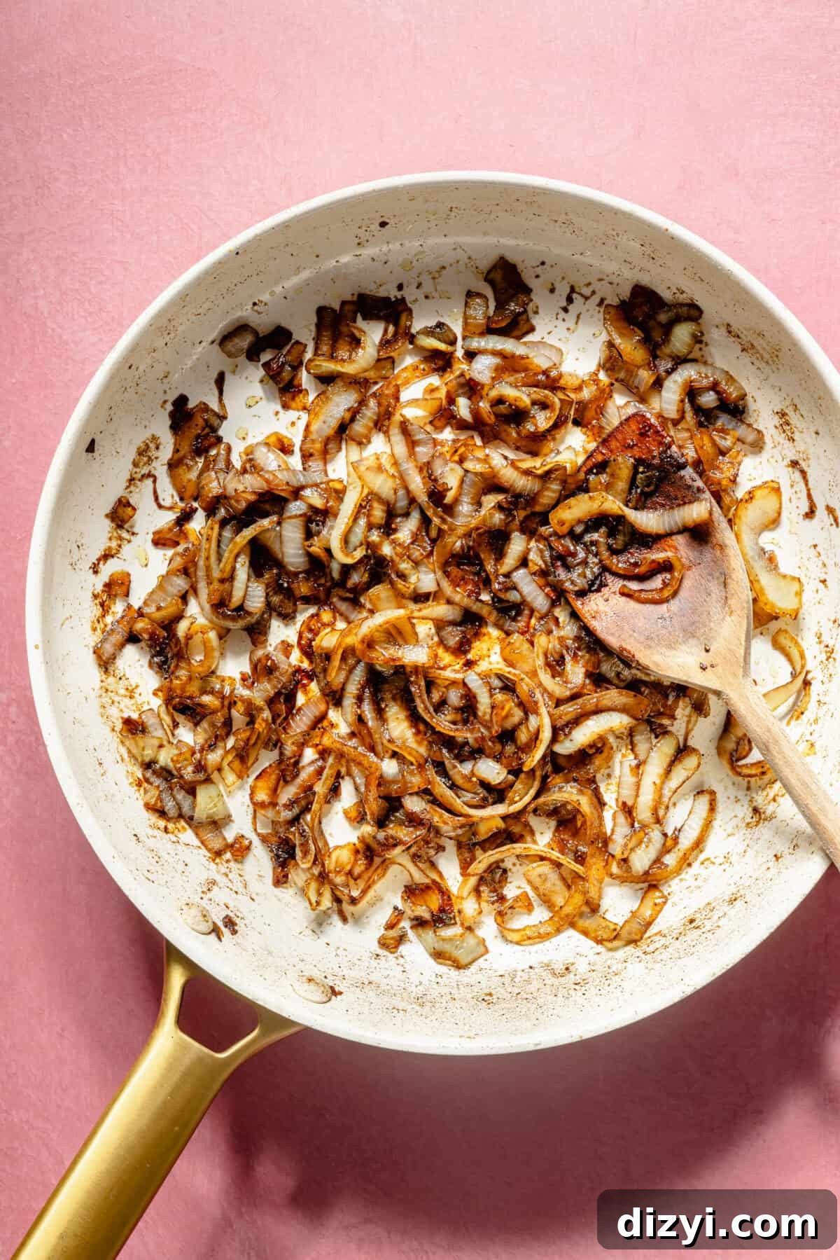 Blue Cheese Burger Salad with Balsamic Vinaigrette 3 A white skillet with thinly sliced caramelized onions
