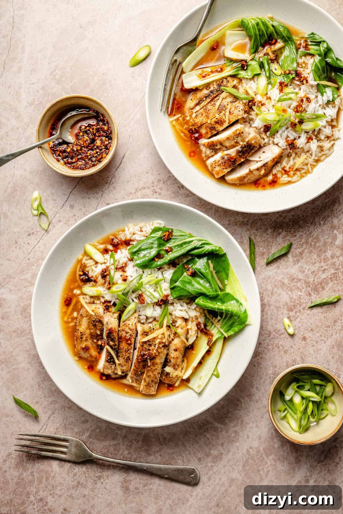 two white plates with sliced chicken thighs, bok choy, white rice, and broth