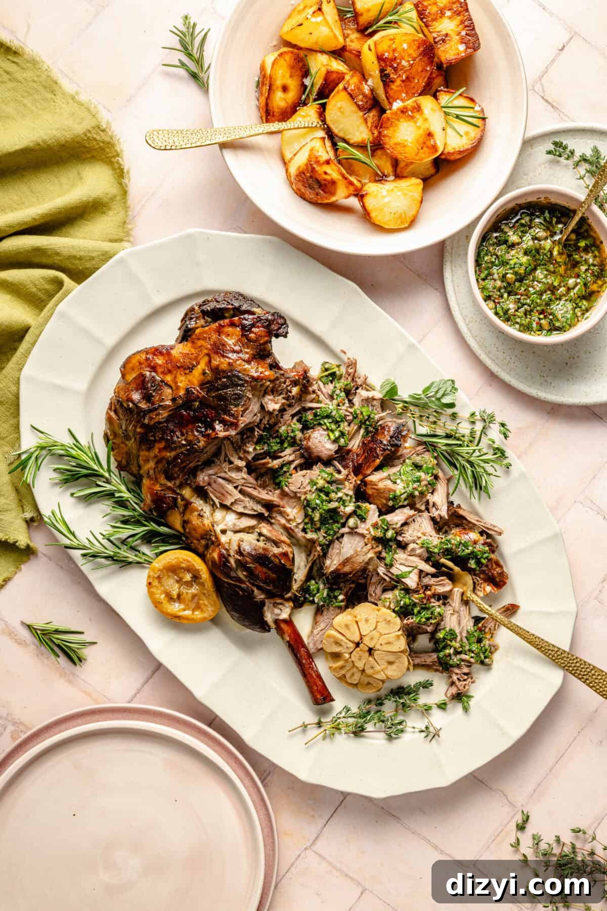 bone-in leg of lamb with herb gremolata and potatoes on a white platter