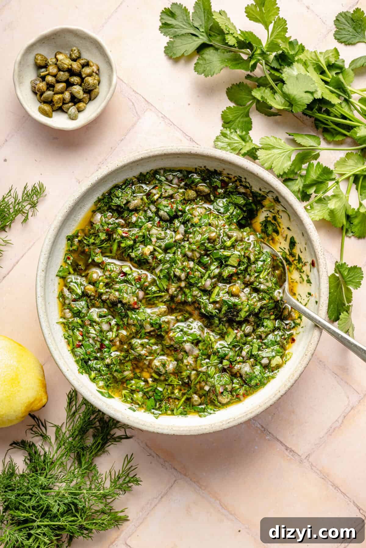 a bowl of herb gremolata with fresh parsley and capers