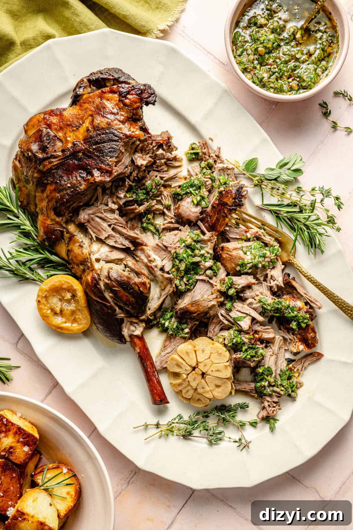 a platter of roasted leg of lamb with fresh herbs