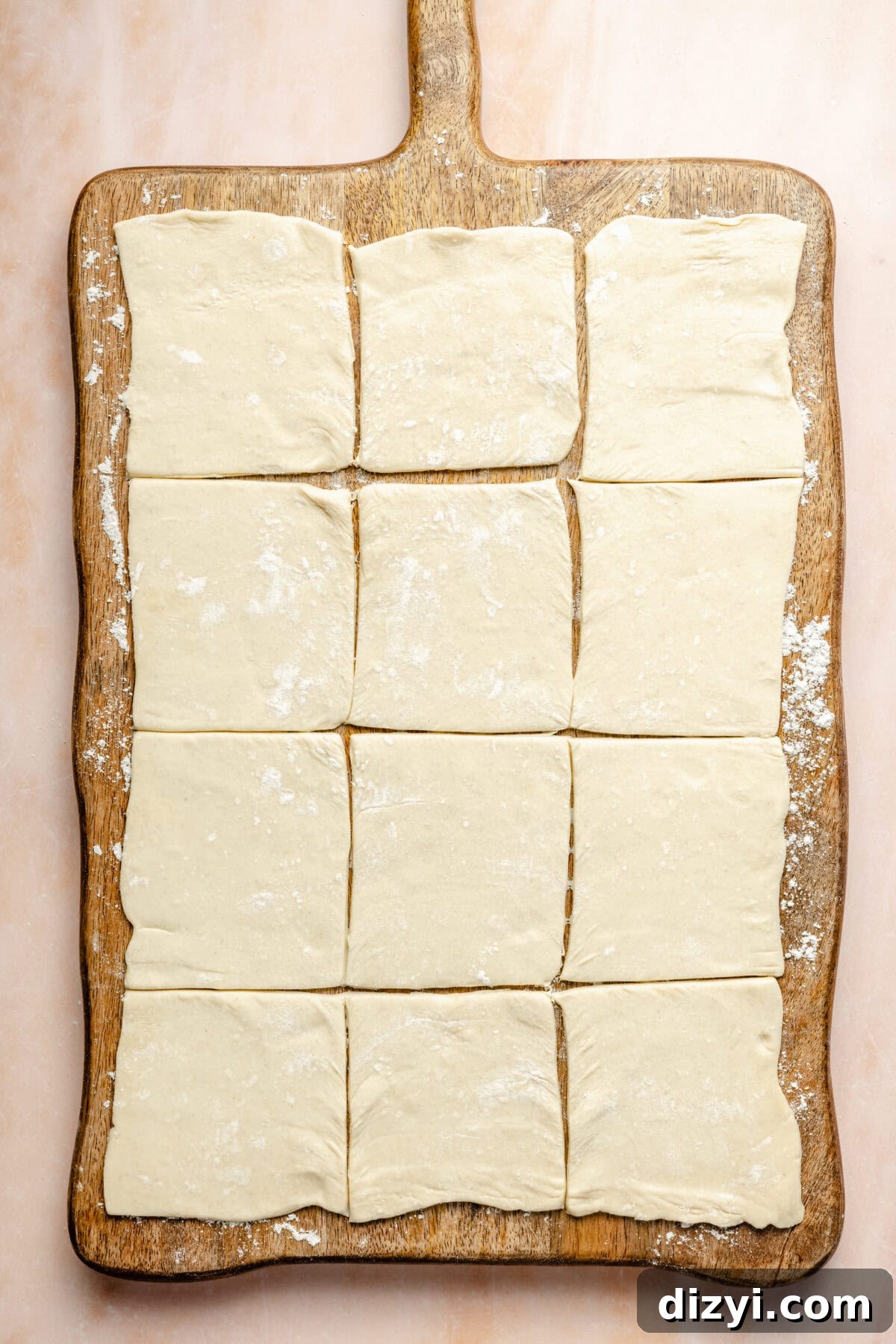 cut squares of puff pastry on a wooden cutting board