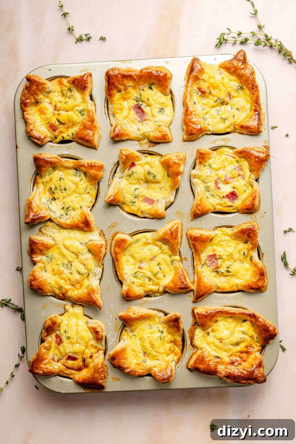 a muffin tin with miniature baked ham and cheese quiches