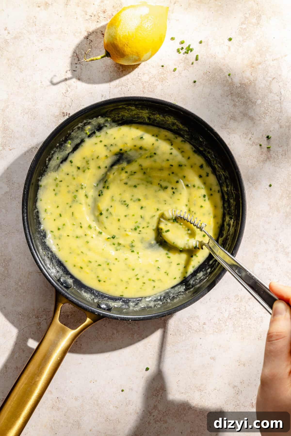 Pan Seared Salmon with Lemon Chive Beurre Blanc Recipe 5 a dark skillet filled with a lemon and chive butter sauce
