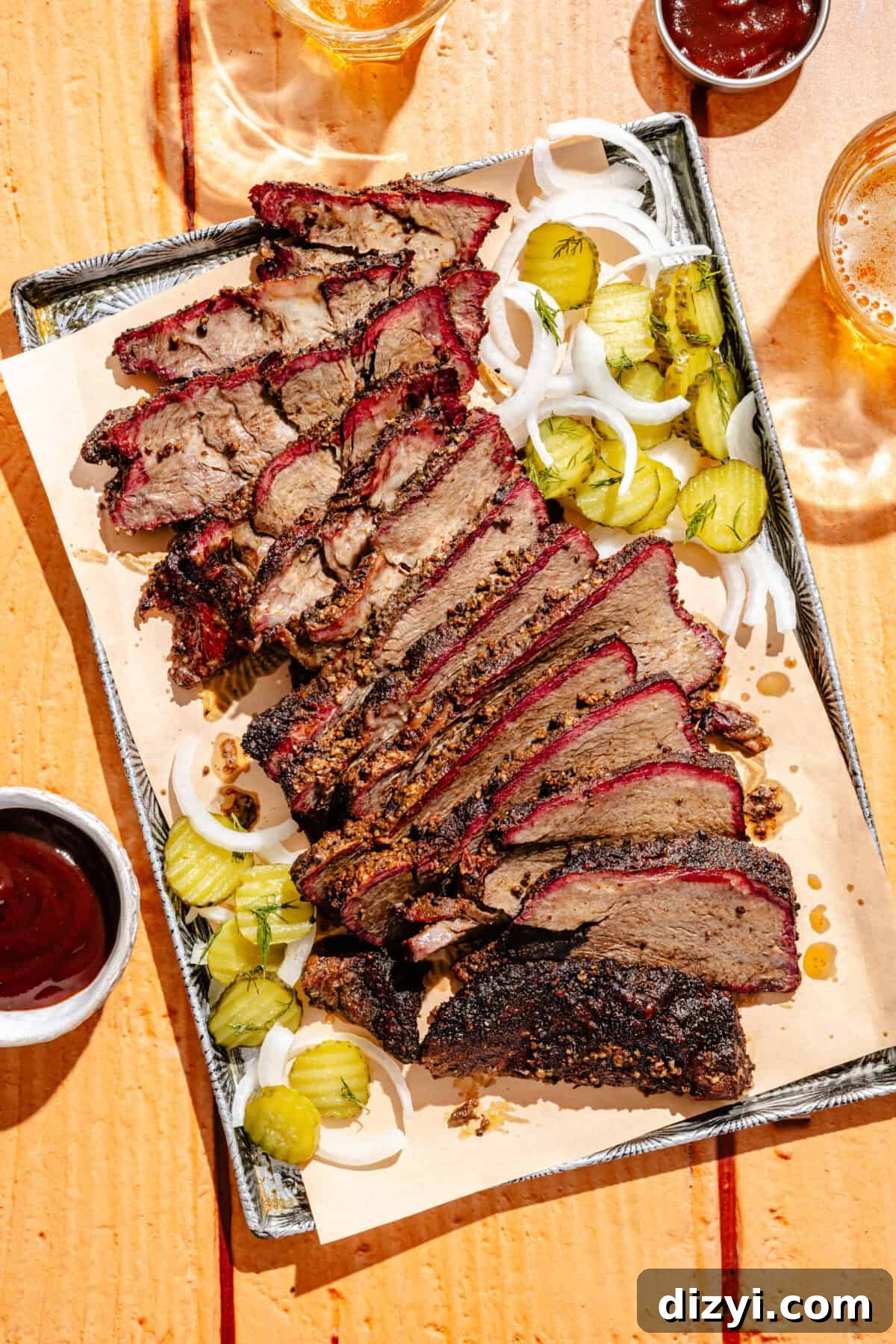 a sheet tray with smoked chuck roast with pickles, onions, and barbecue sauce