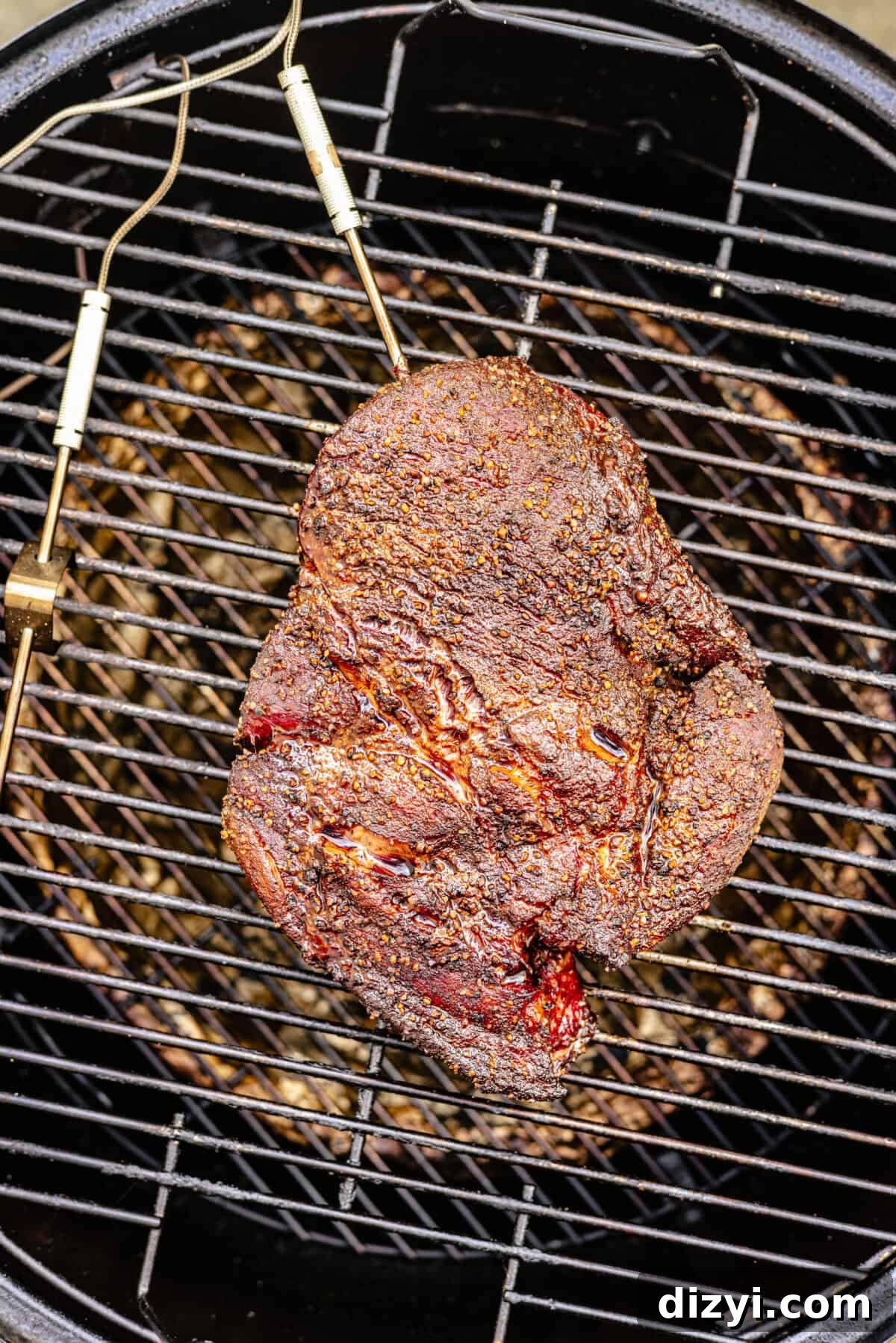 chuck roast on a wire rack set in a smoker
