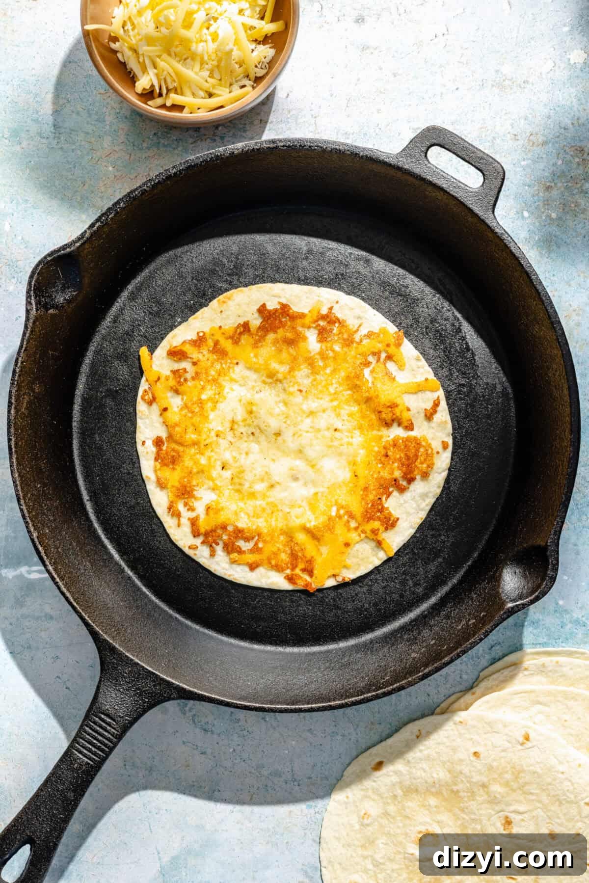 cheese-crusted flour tortillas in a cast-iron skillet