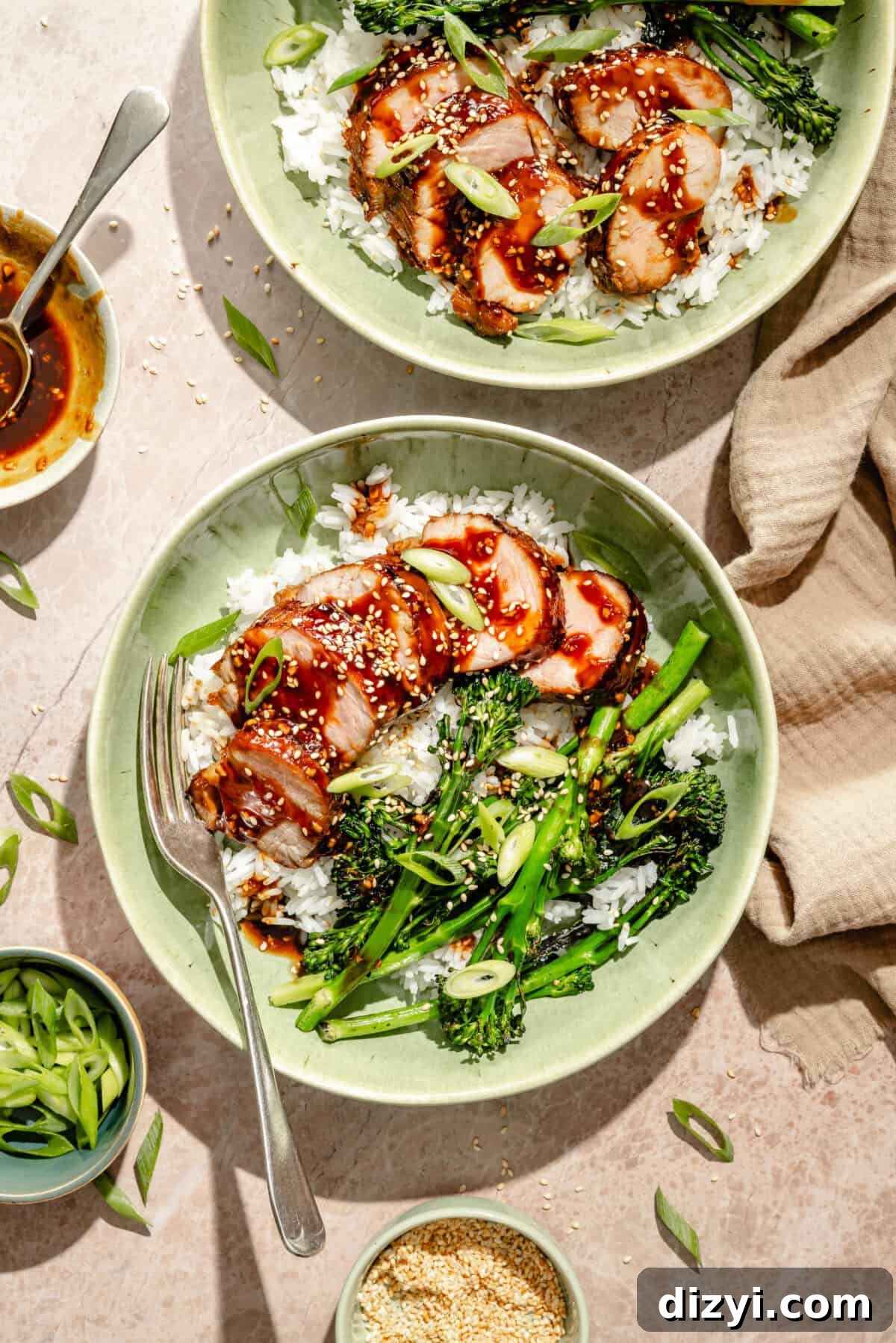Grilled Pork Tenderloin Bowls with Hoisin Glaze 2 bowls of glazed and grilled pork tenderloin over rice with broccoli