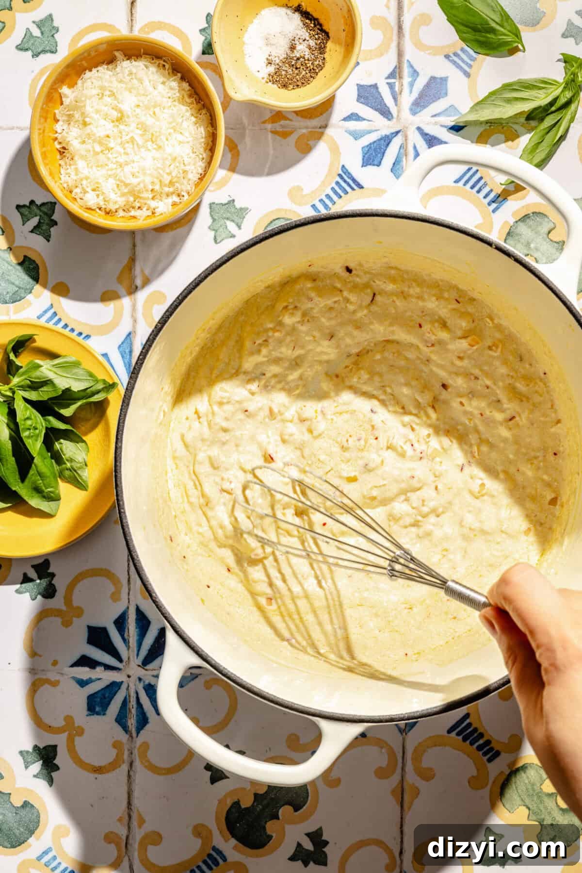 Creamy Lemon Pasta with Ricotta and Basil sauce getting whisked in pot.