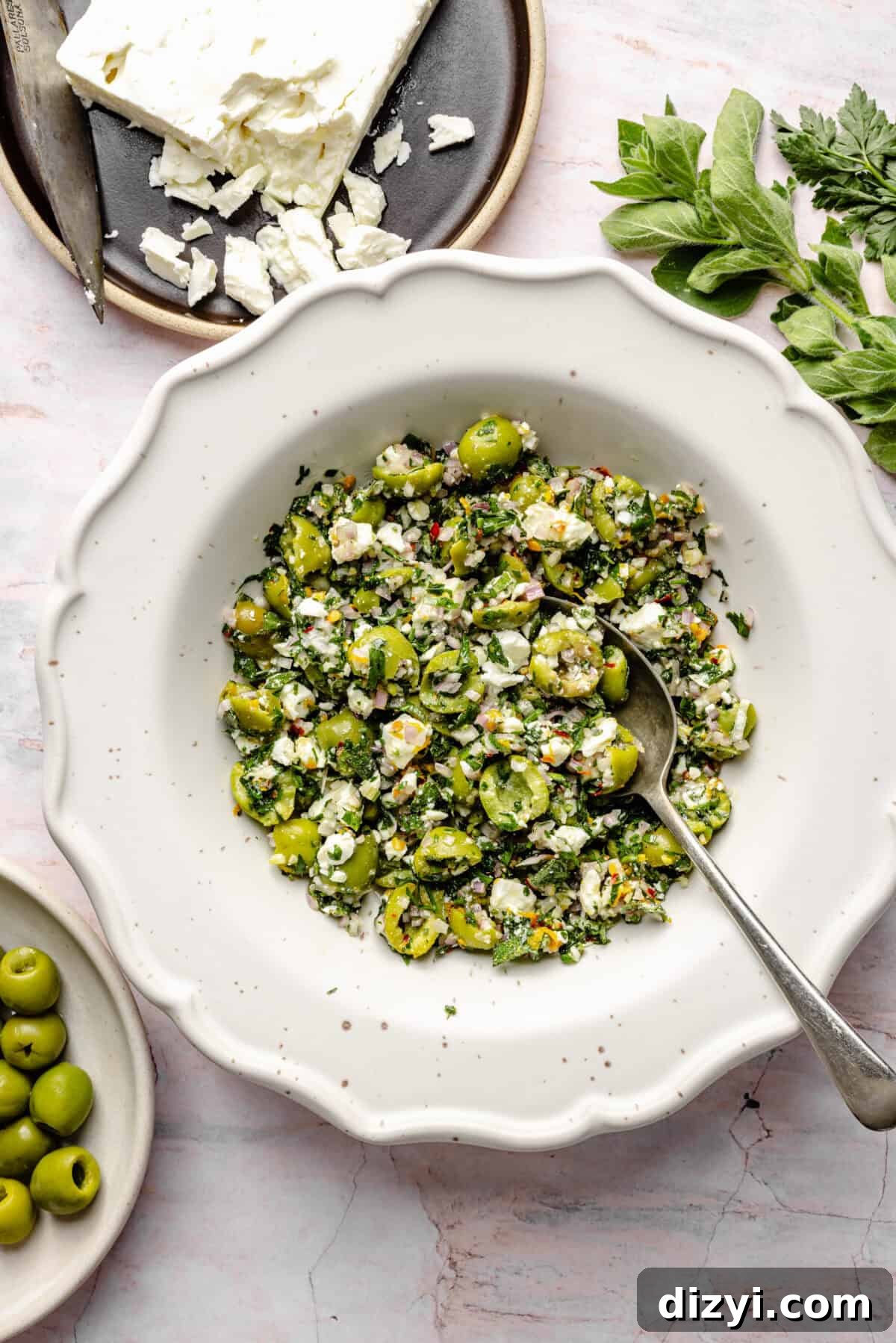 Castelvetrano Olive and Feta Salsa in bowl with spoon.