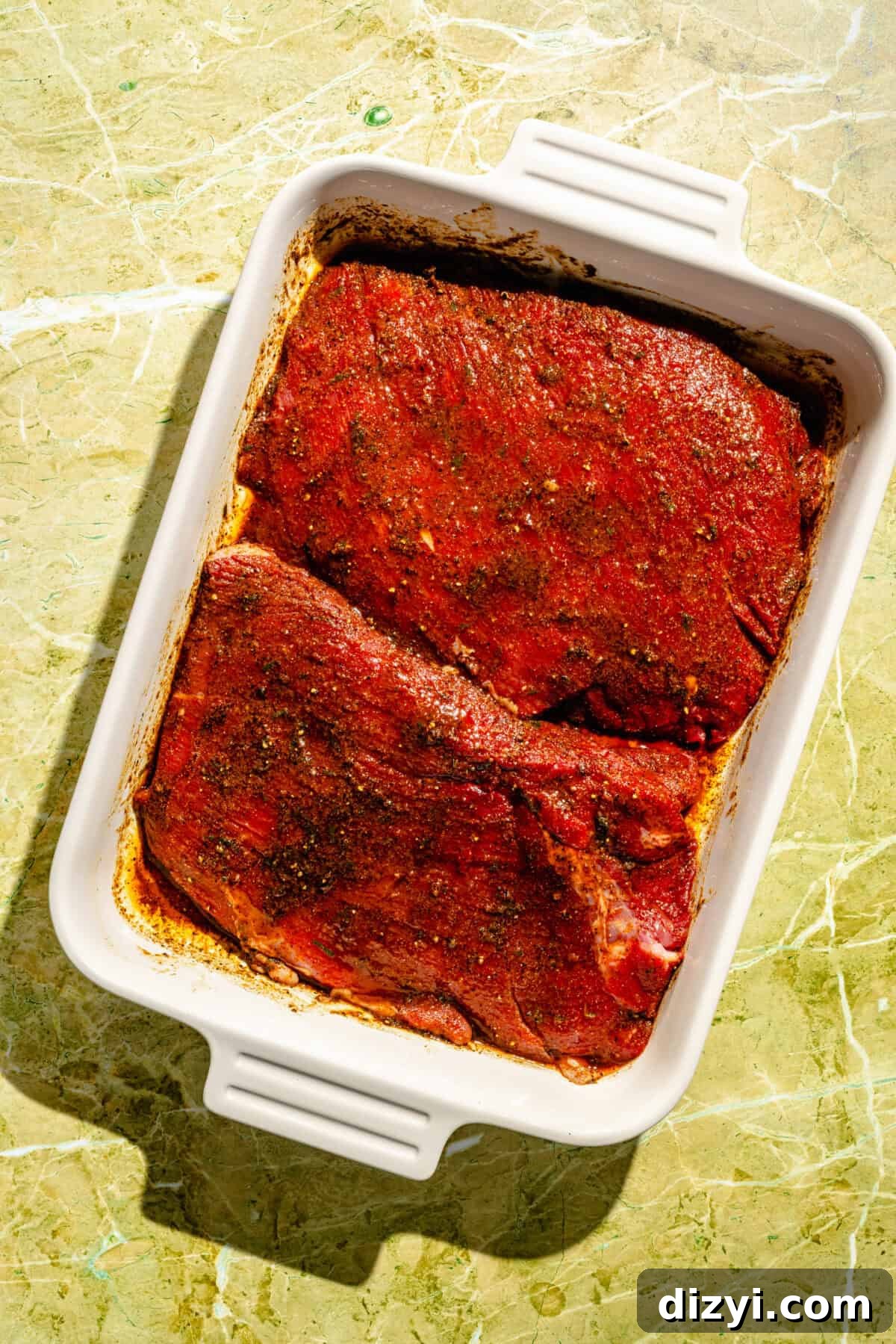 Flap Steak marinating in baking dish.