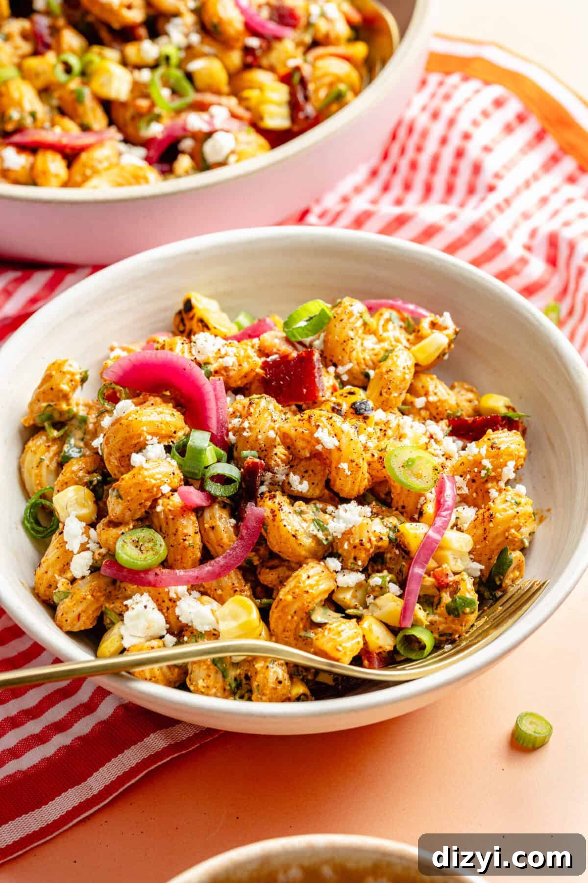 Smoky Chipotle Bacon Pasta Salad Recipe 2 Smokey Chipotle Bacon Pasta Salad in white bowl on pink backdrop.