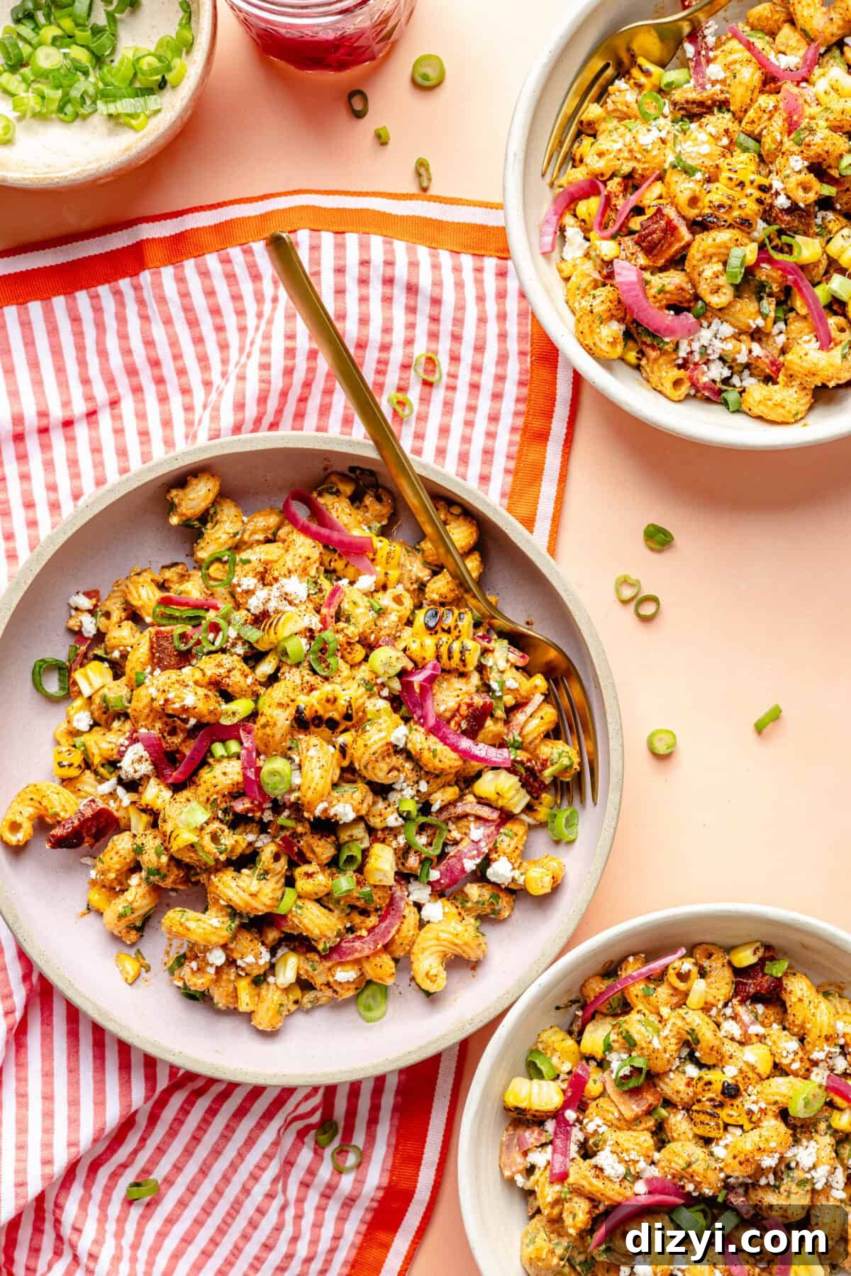 Smoky Chipotle Bacon Pasta Salad Recipe 3 Smoky Chipotle Bacon Pasta Salad in bowls on pink surface.